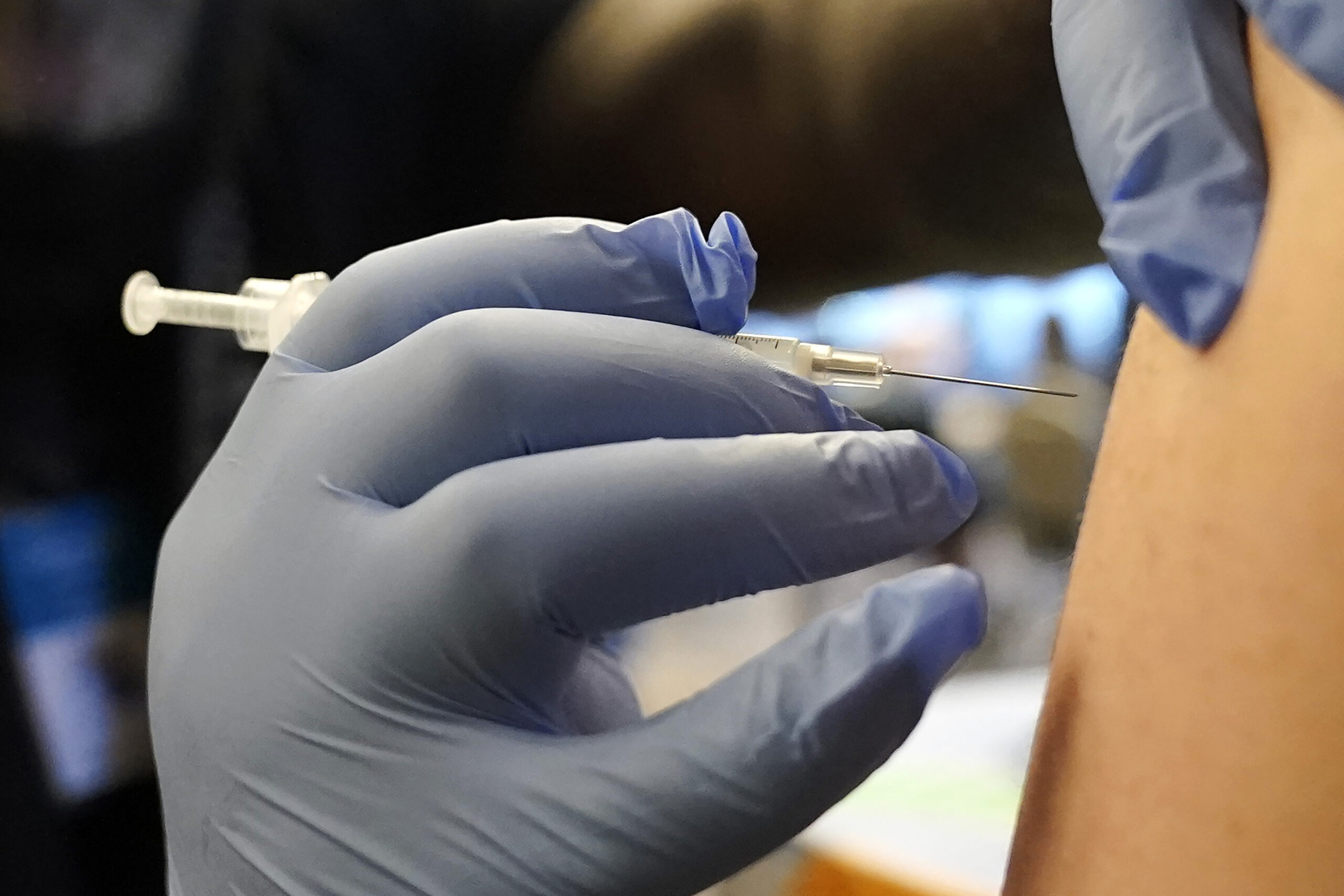 A person receives a Pfizer COVID-19 vaccine booster shot, Dec. 20, 2021
