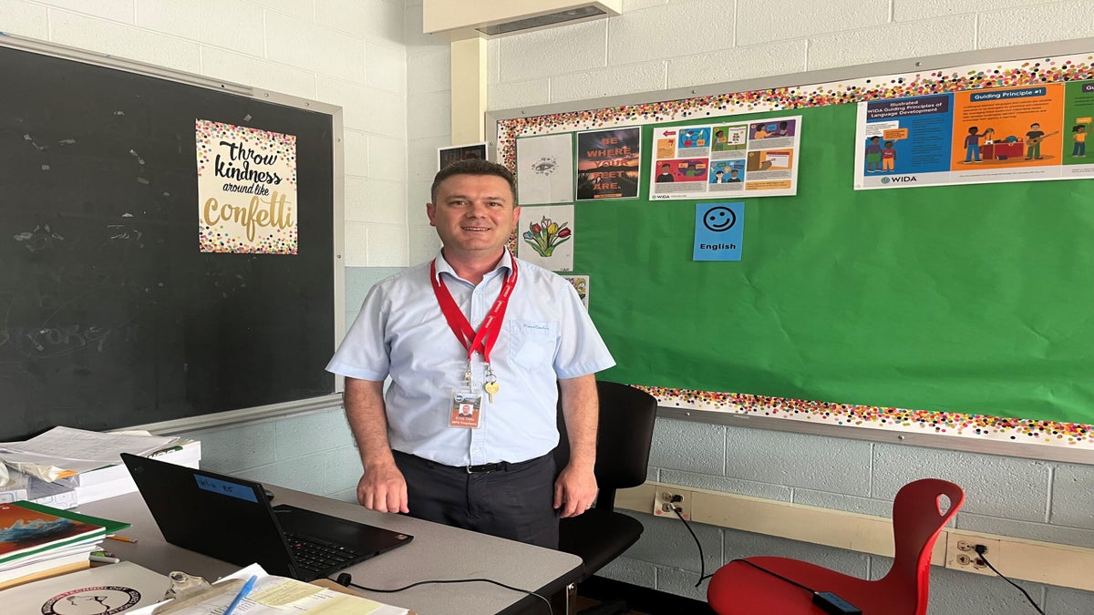 Ervis Veliu, an international teacher hired by Milwaukee Public Schools, poses at his desk
