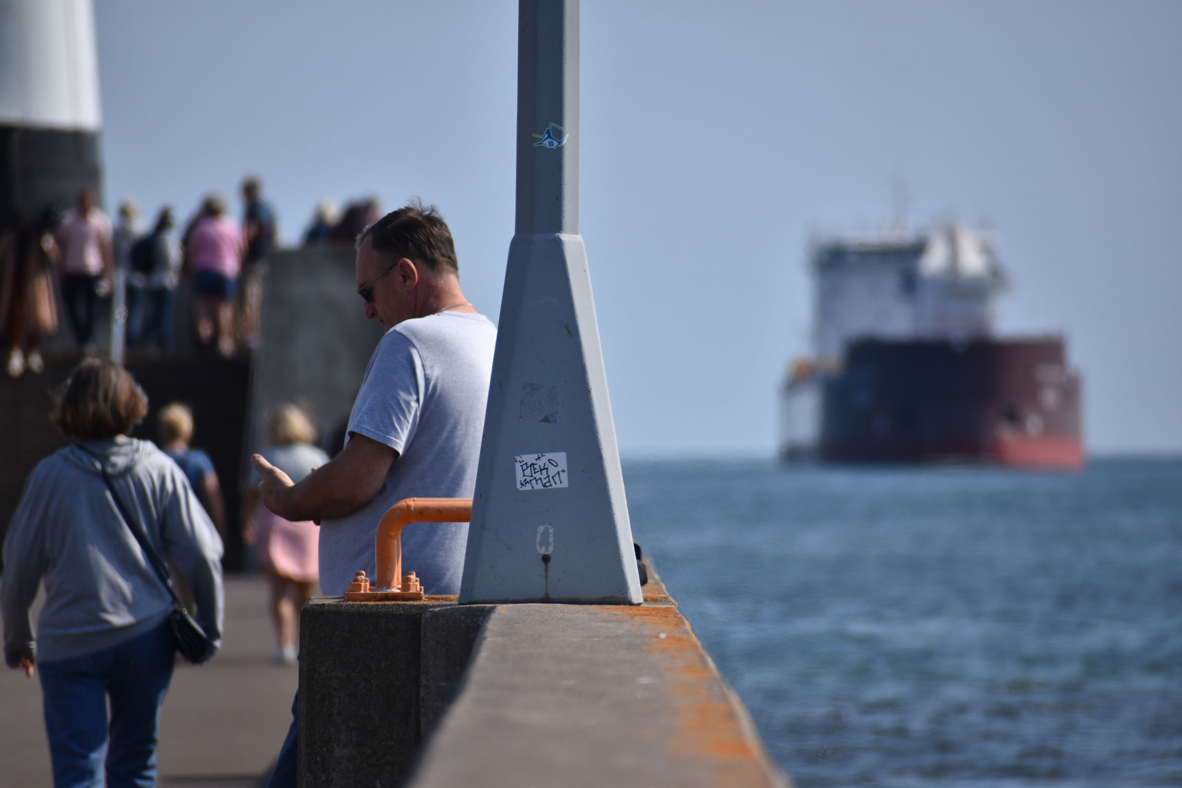 People watch the Mark W. Barker sail into the Twin Ports