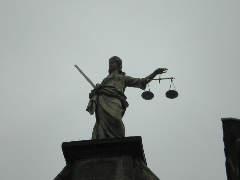 A statue of Lady Justice on top of a building