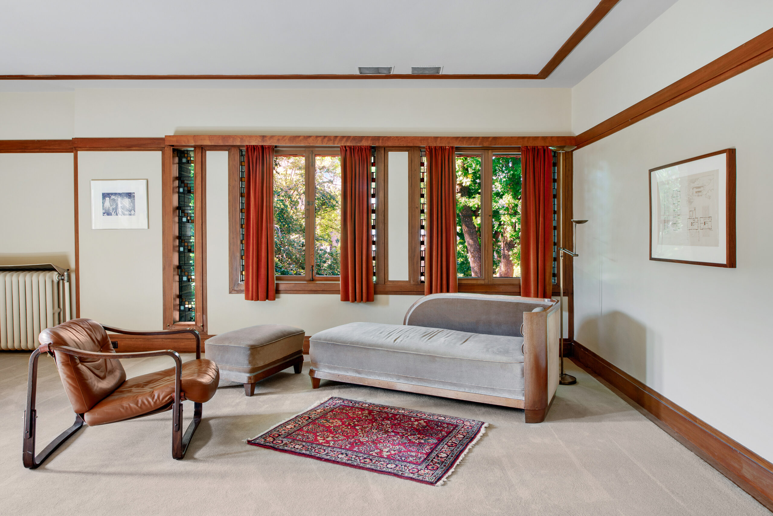 A living room space with a couch, chair, and rug.