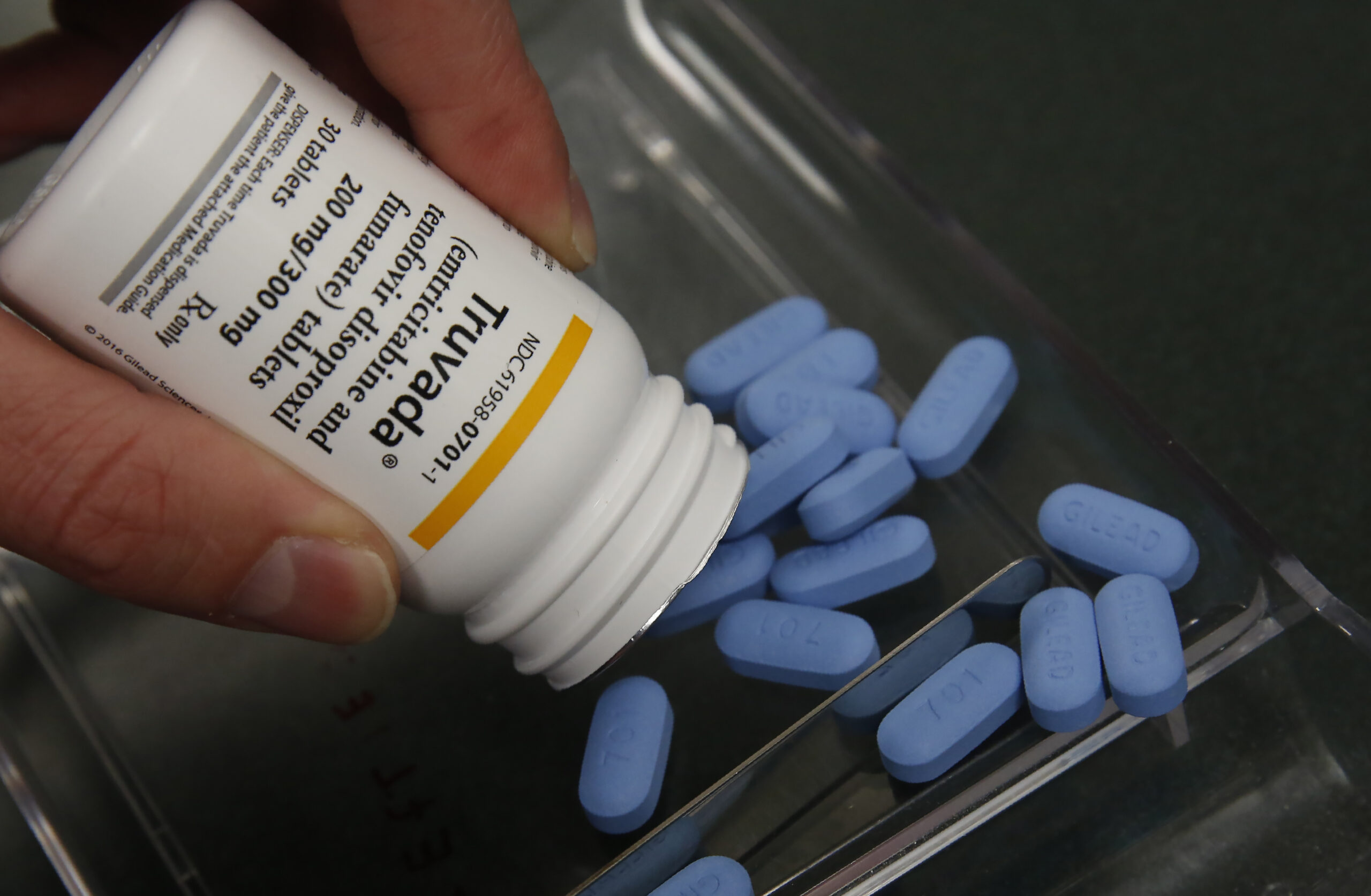 a pill bottle and blue pills