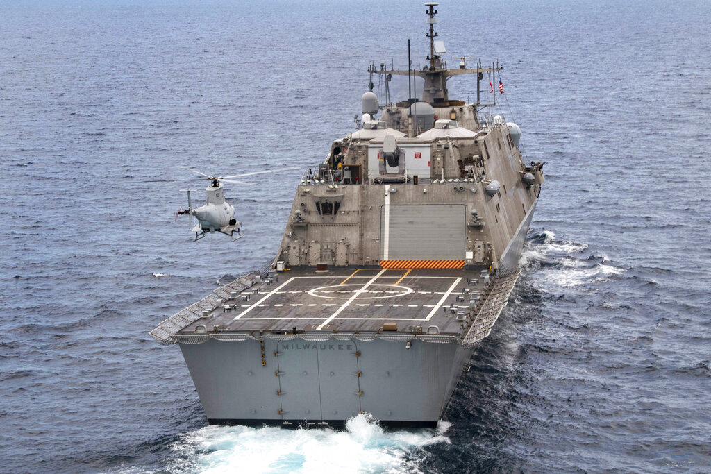 The USS Milwaukee, a Freedom-class of littoral combat ship, cruises underway as an MQ-8B Fire Scout unmanned aerial vehicle hovers during flight operations on June 27, 2019, in the Atlantic Ocean.