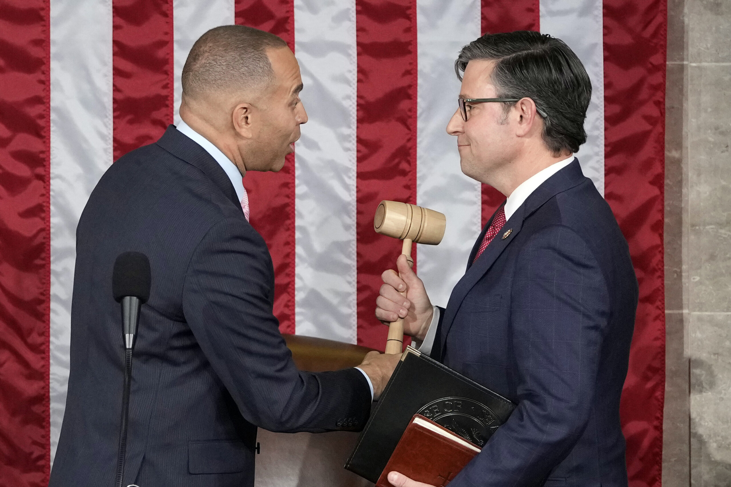 House Democratic Minority Leader Hakeem Jeffries of New York hands the gavel to Republican speaker-elect Mike Johnson of Louisiana at the Capitol in Washington.