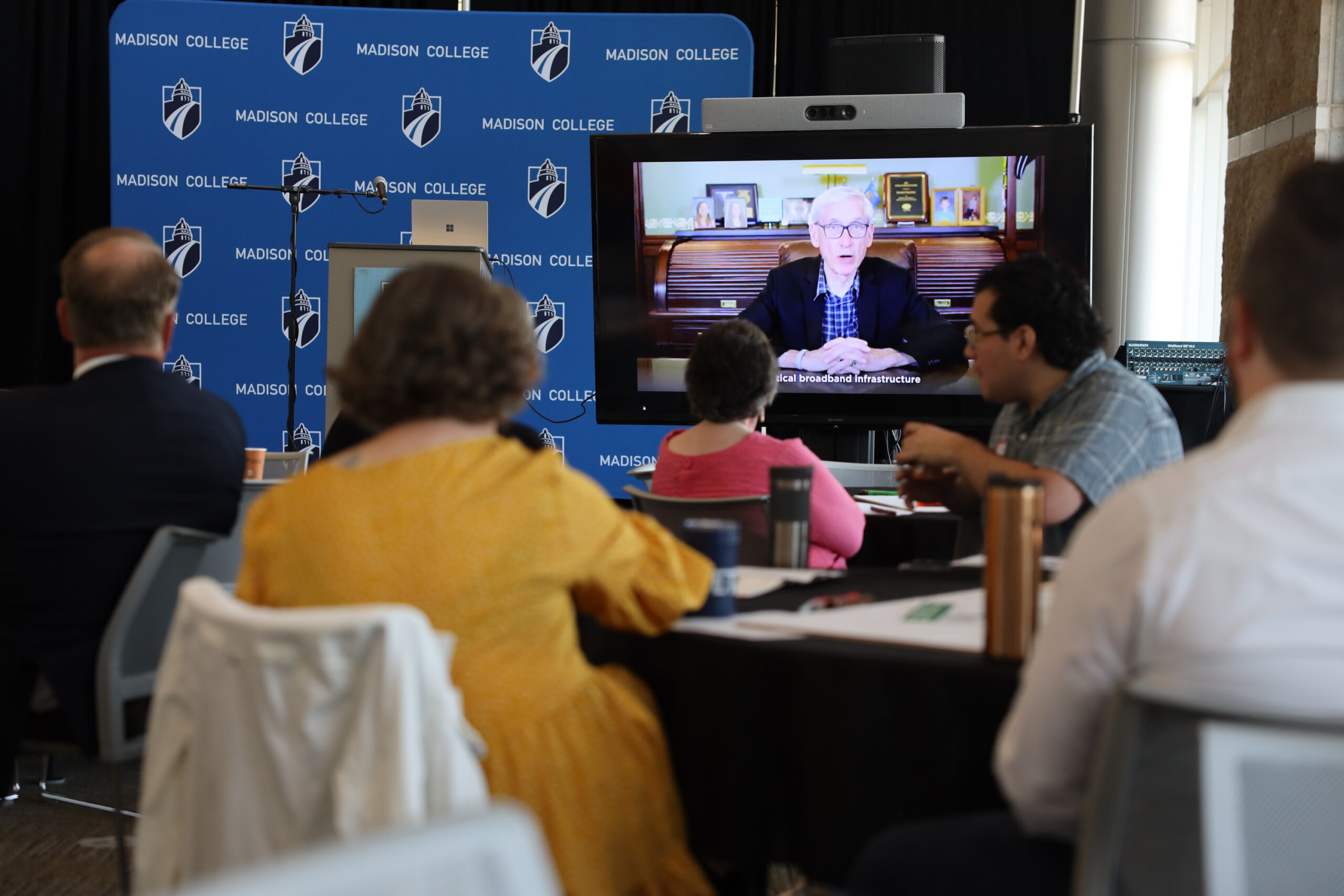 A video showing Democratic Gov. Tony Evers speaking about broadband access plays during a Public Service Commission of Wisconsin Internet for All listening tour