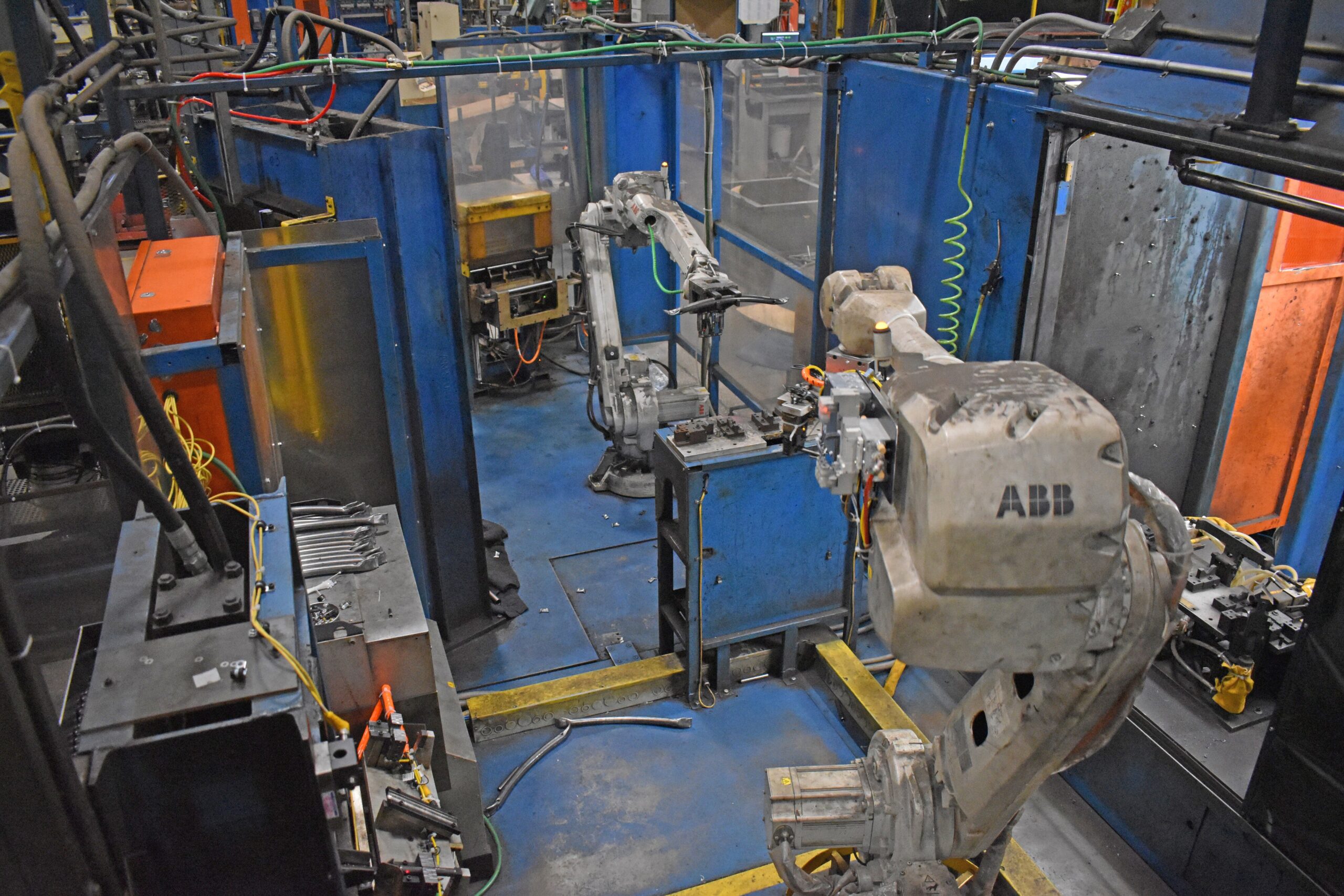 Robotic arms grab metal pieces at furniture manufacturer KI's Green Bay plant.