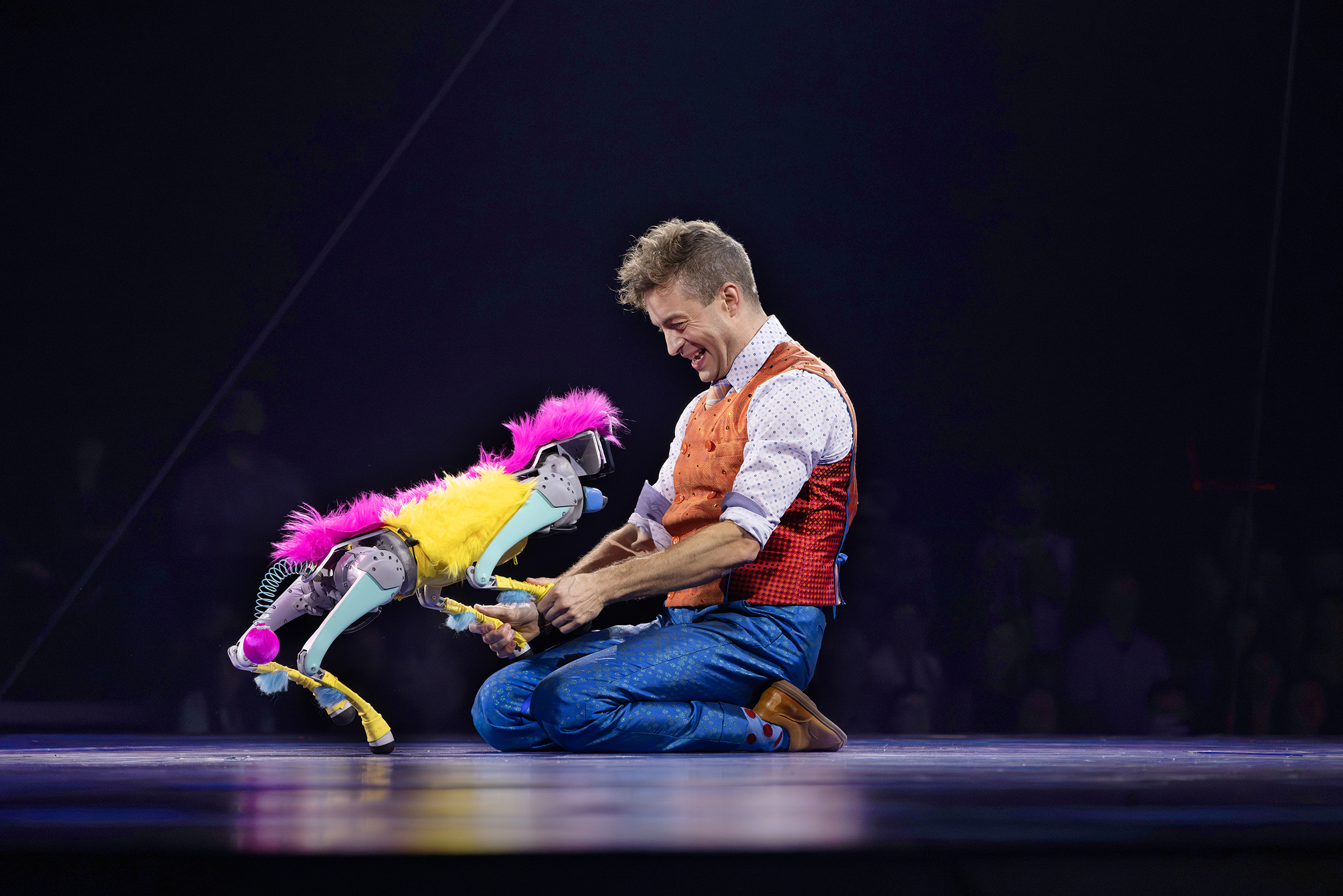 Jan Damm, who plays Nick Nack, an acrobatic comedian and show guide, has fun alongside Bailey, a robotic dog. Photo courtesy of Feld Entertainment. 