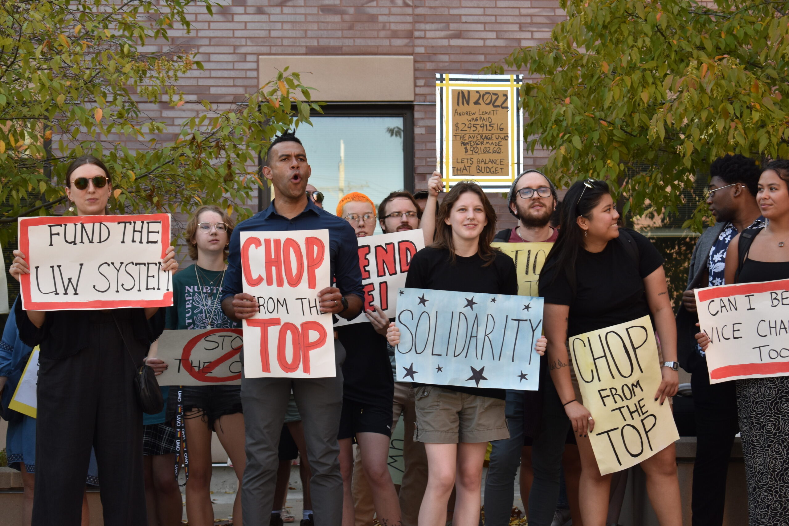 Campus community members gather outside of Sage Hall at UW-Oshkosh