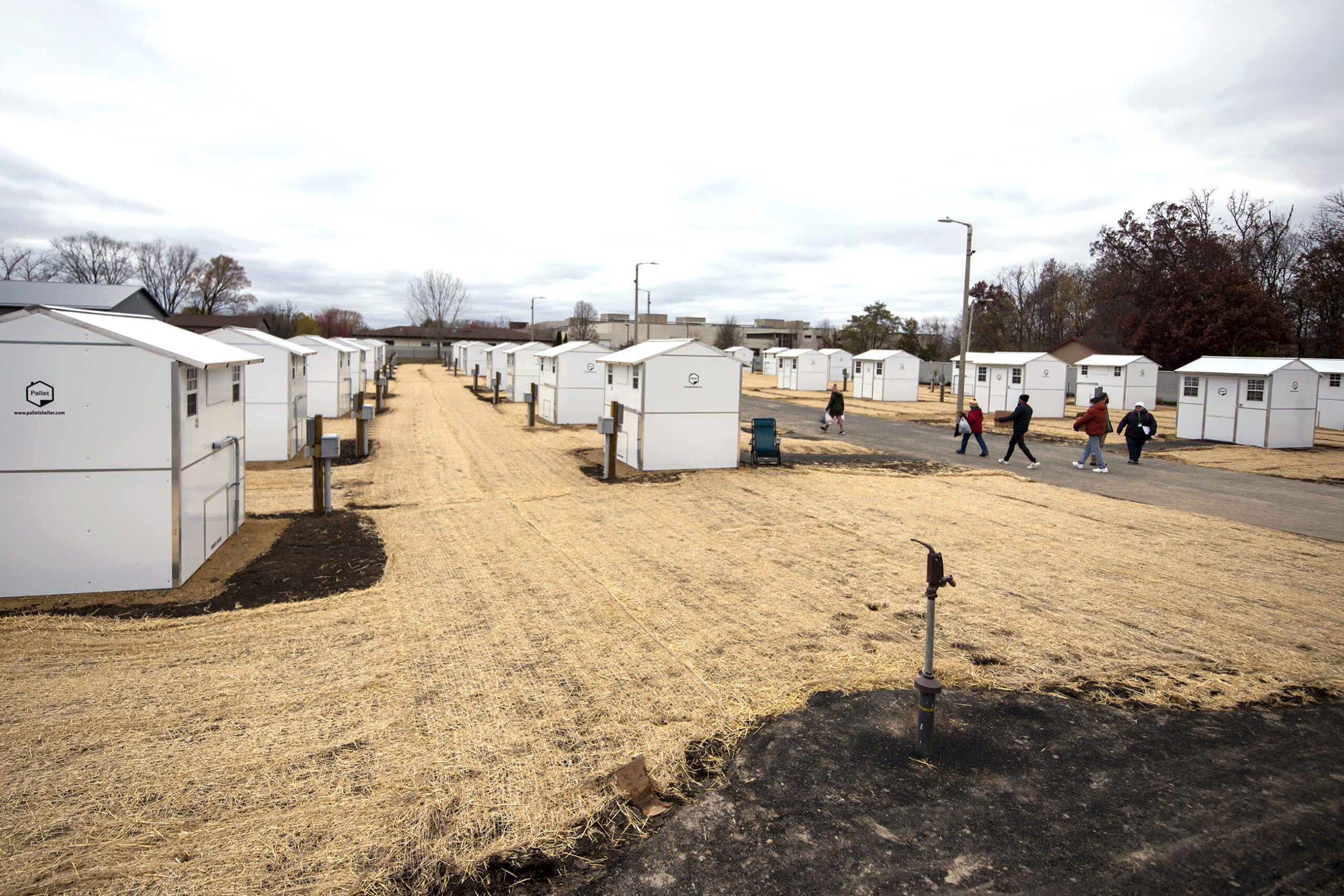 Small white homes are set up in a residential space.