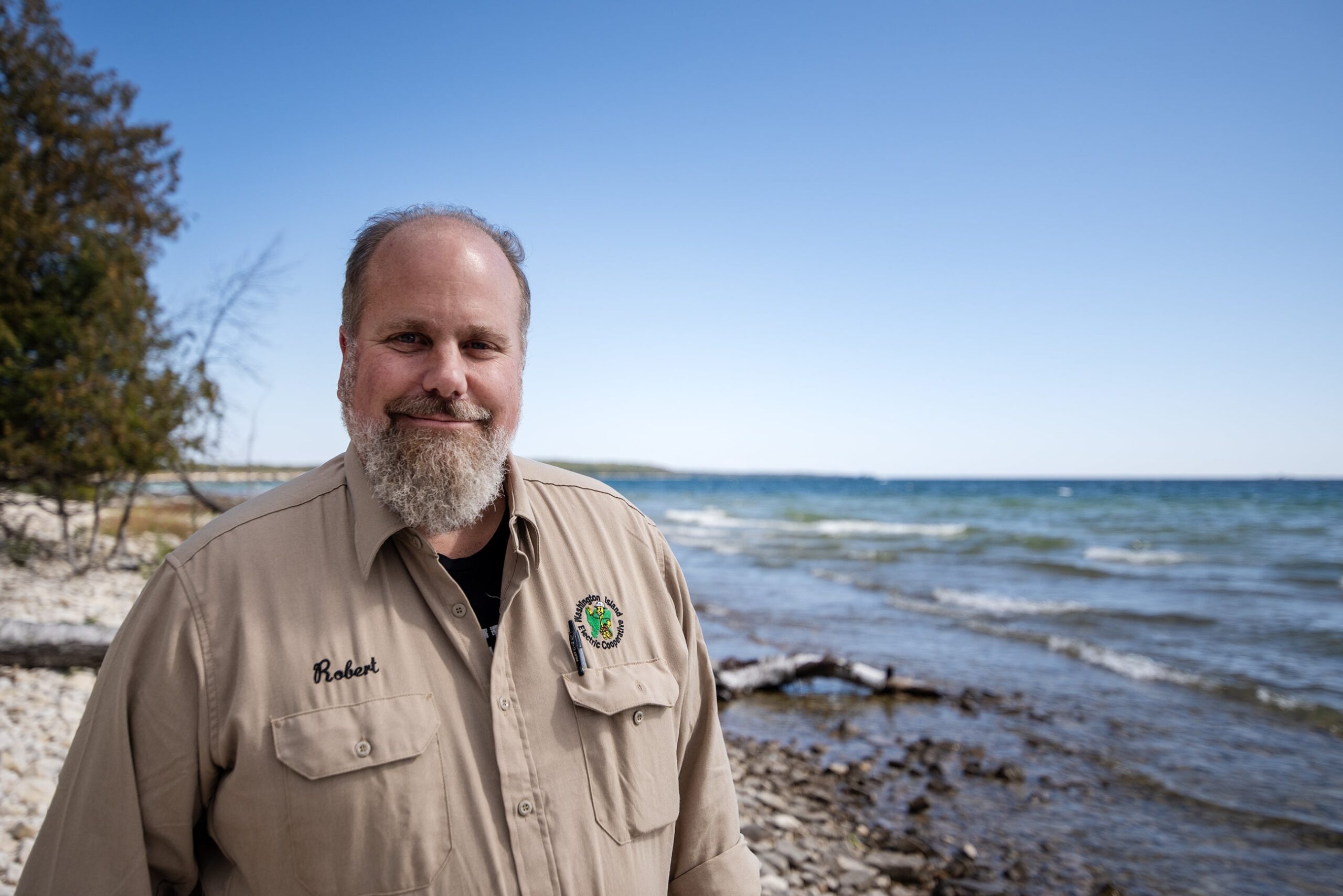 Robert stands near the shore.