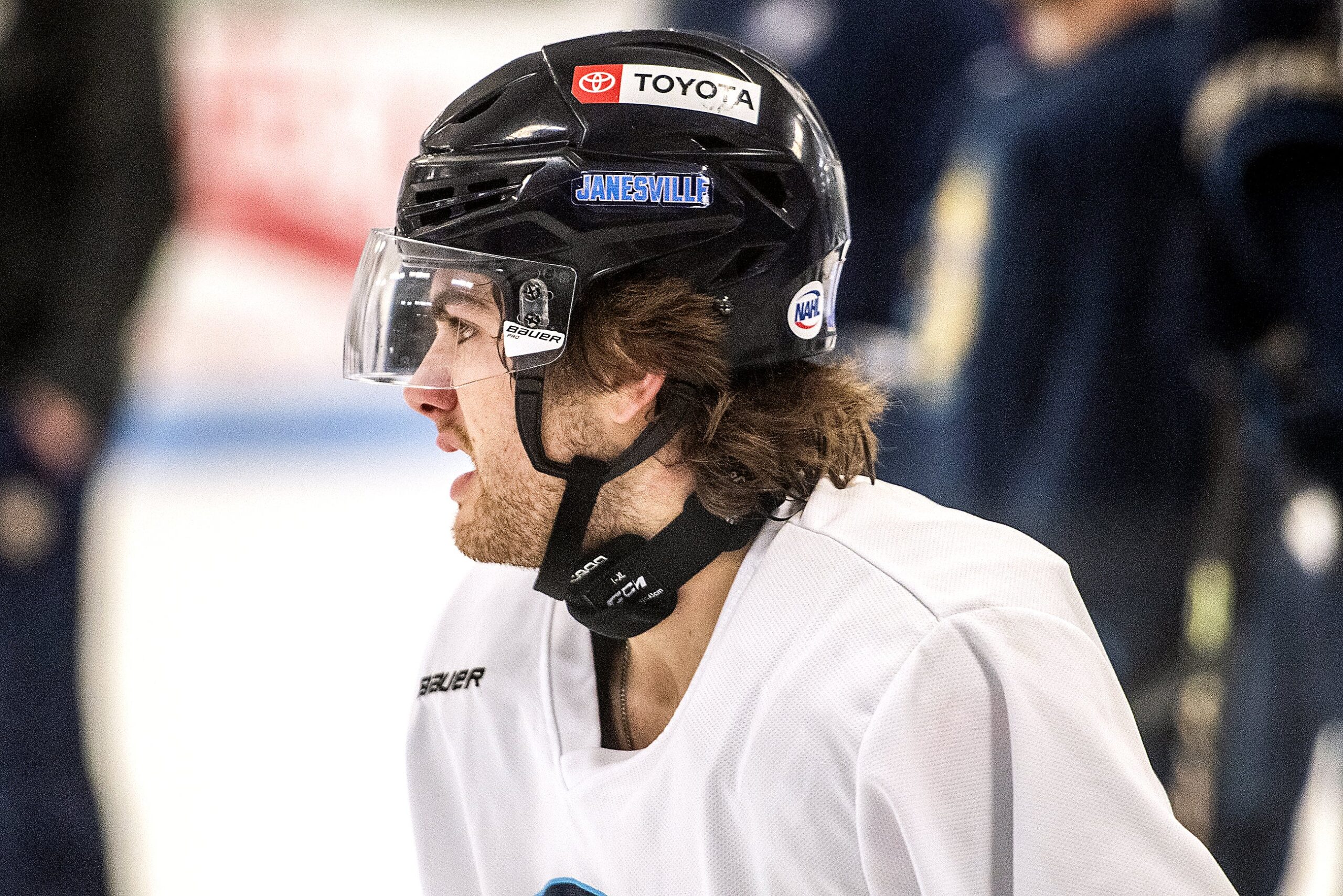 A player wears a helmet and a neck guard, which wraps around his neck and covers the front of it.