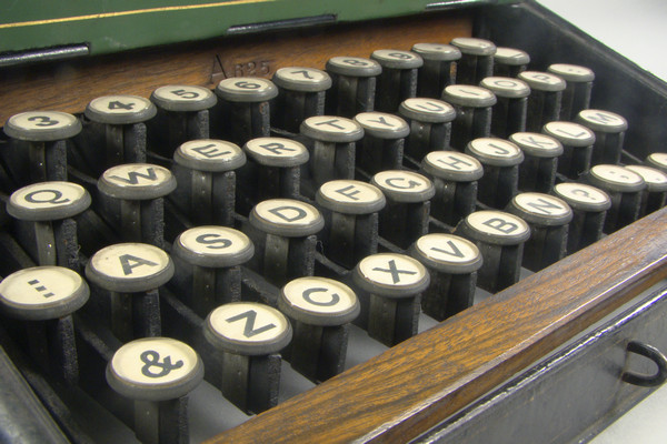 An antique typewriter with a QWERTY keyboard