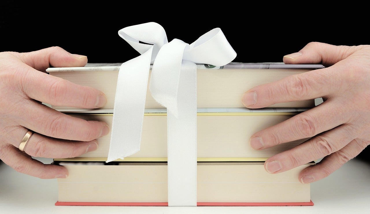 Stack of three books tired with a ribbon.