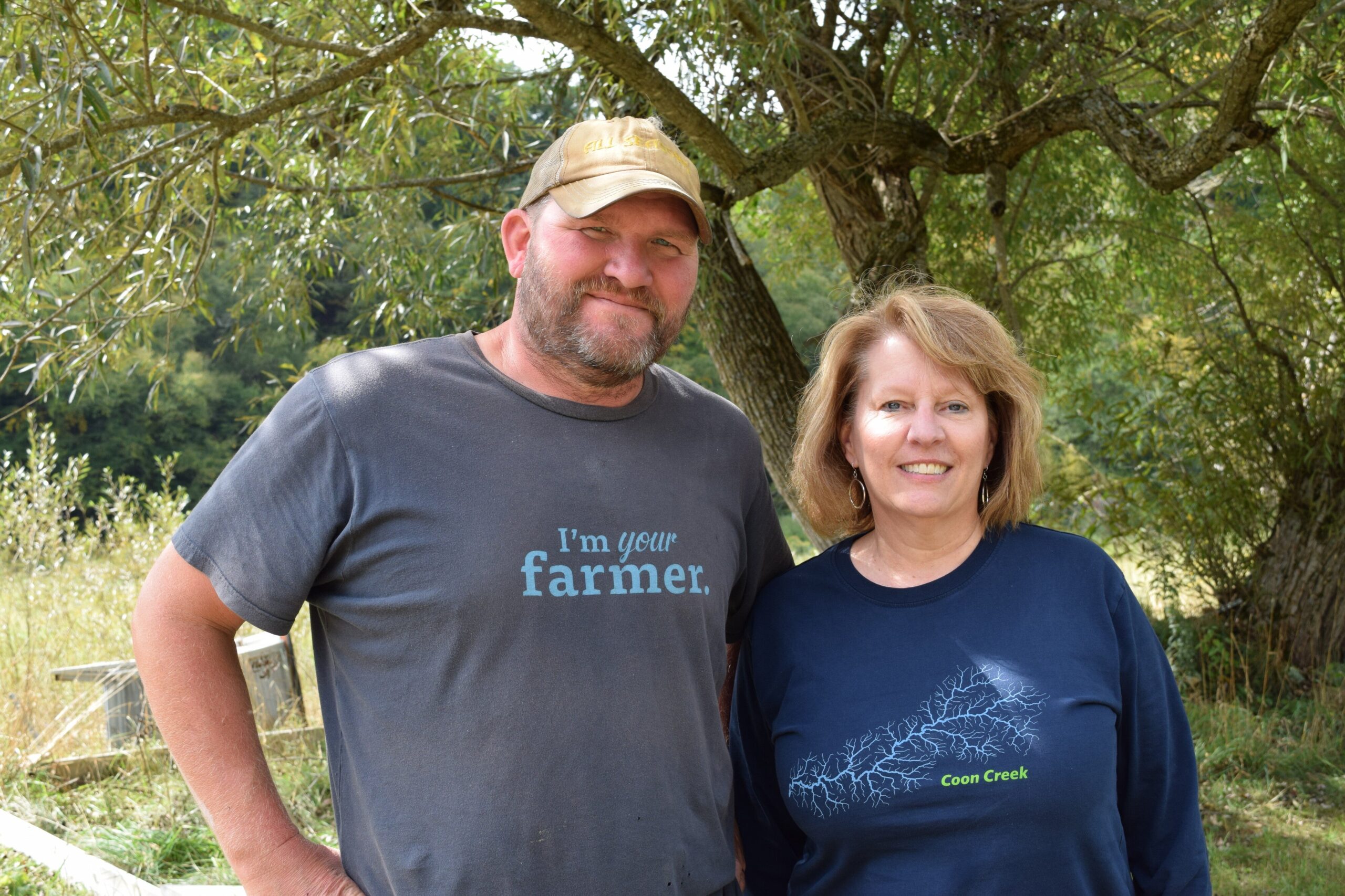 Gretebeck and Wedwick stand in front of a tree