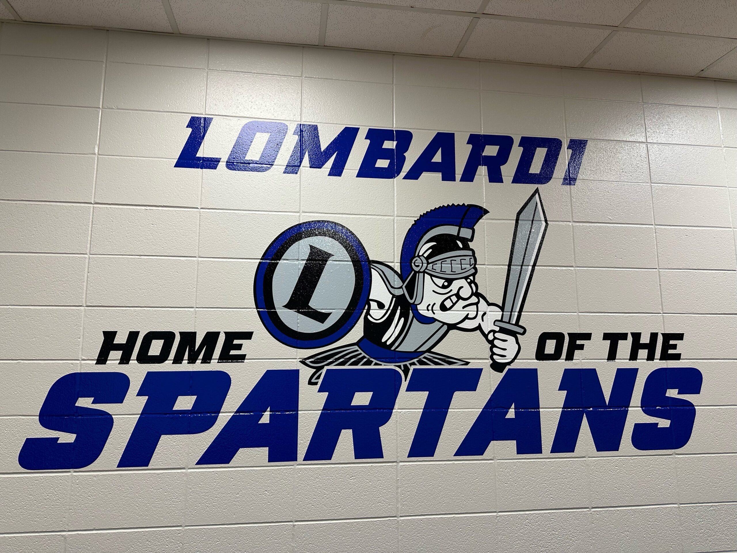 A decorated wall showing the name Lombardi Middle School and their mascot, the Spartans