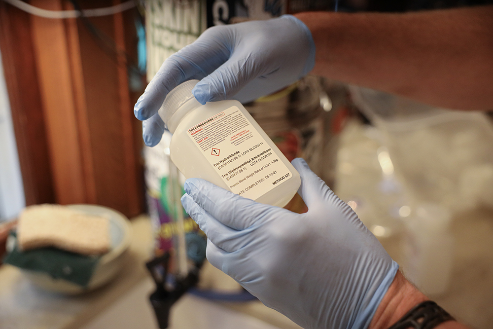 Madison resident Brad Horn collects a water sample to test for PFAS.