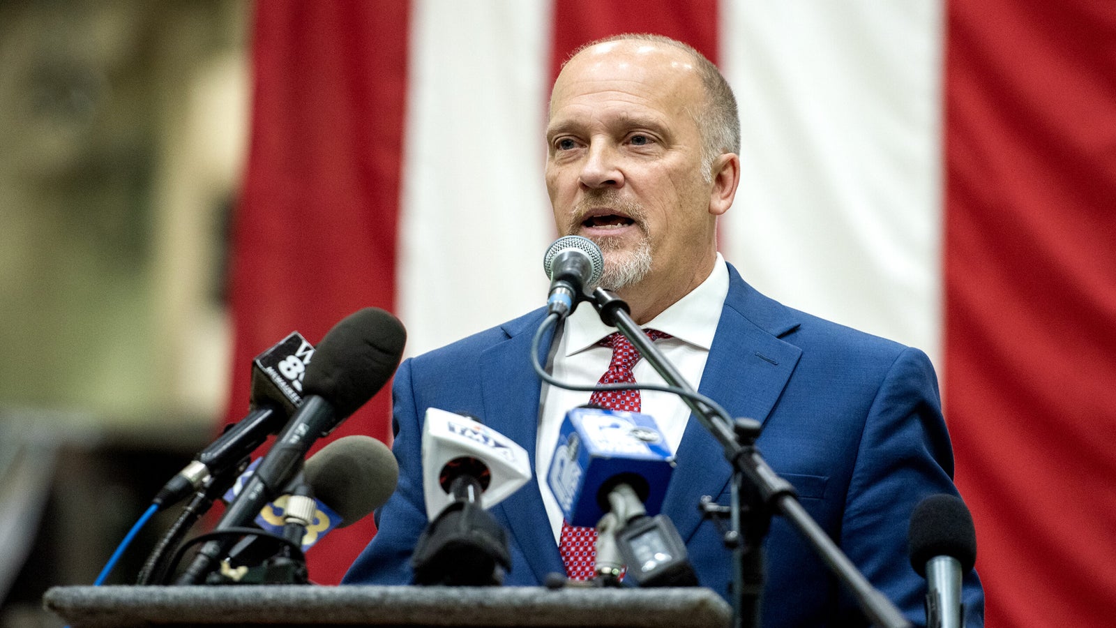 A vertical US Flag is seen behind Brad Schimel as he speaks.
