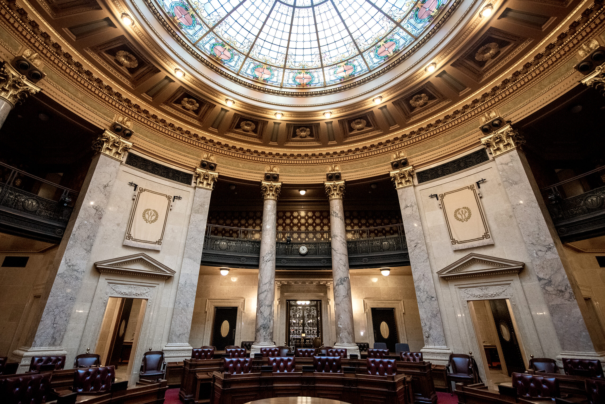 A wide view of the Senate chambers showing the seats and rotunda ceiling.