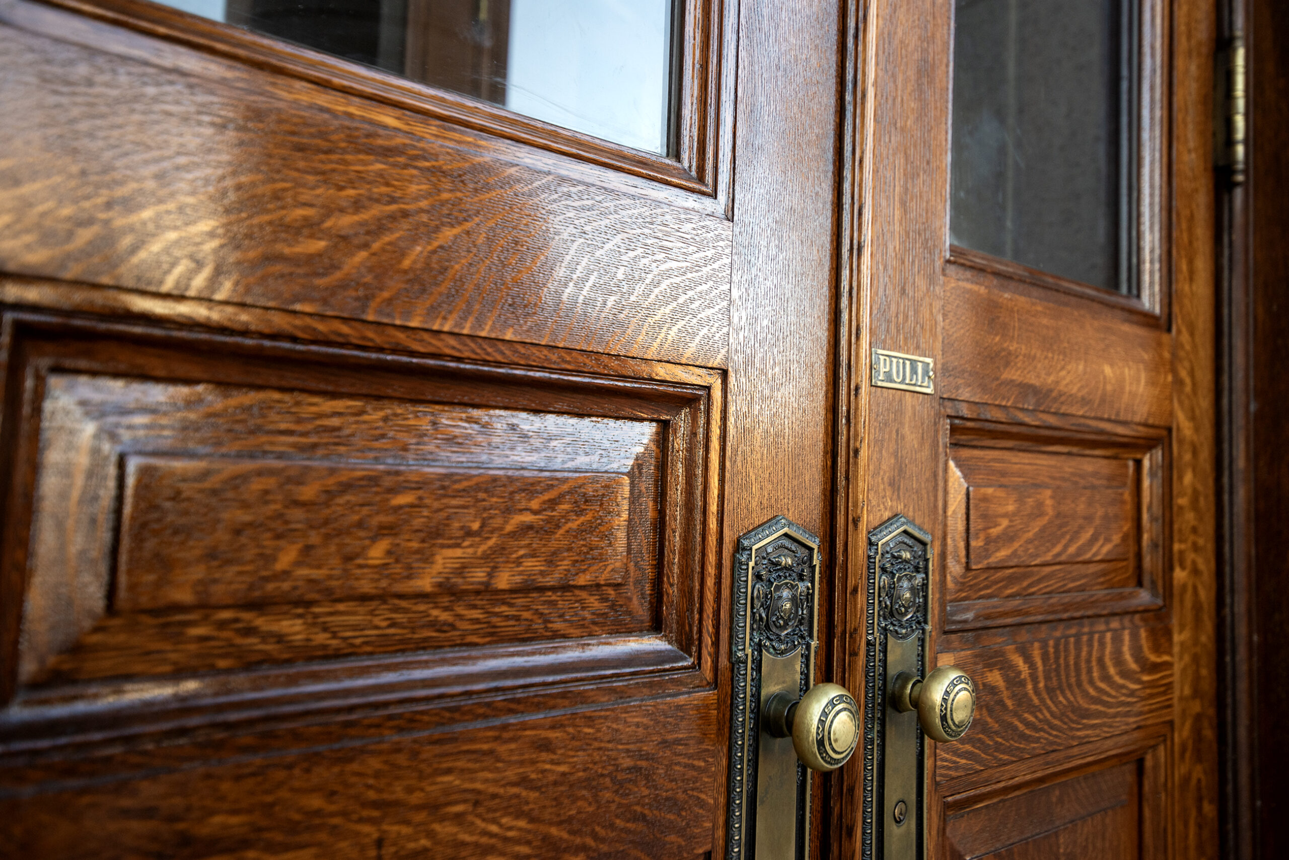 Wooden doors with a shiny finish and old door handle.