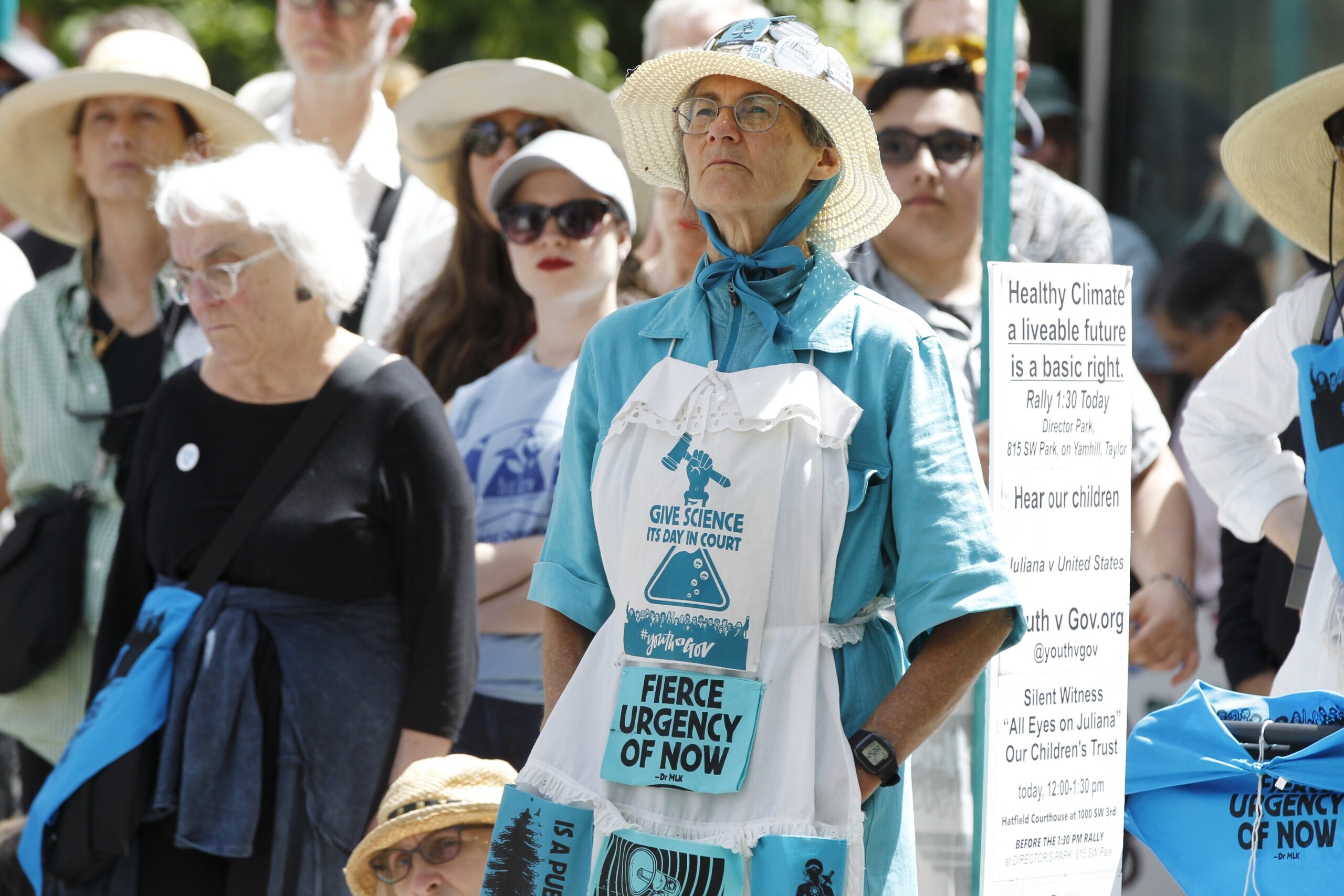 Supporters attend a rally Tuesday, June 4, 2019 for a group of young people who filed a lawsuit saying U.S. energy policies are causing climate change and hurting their future