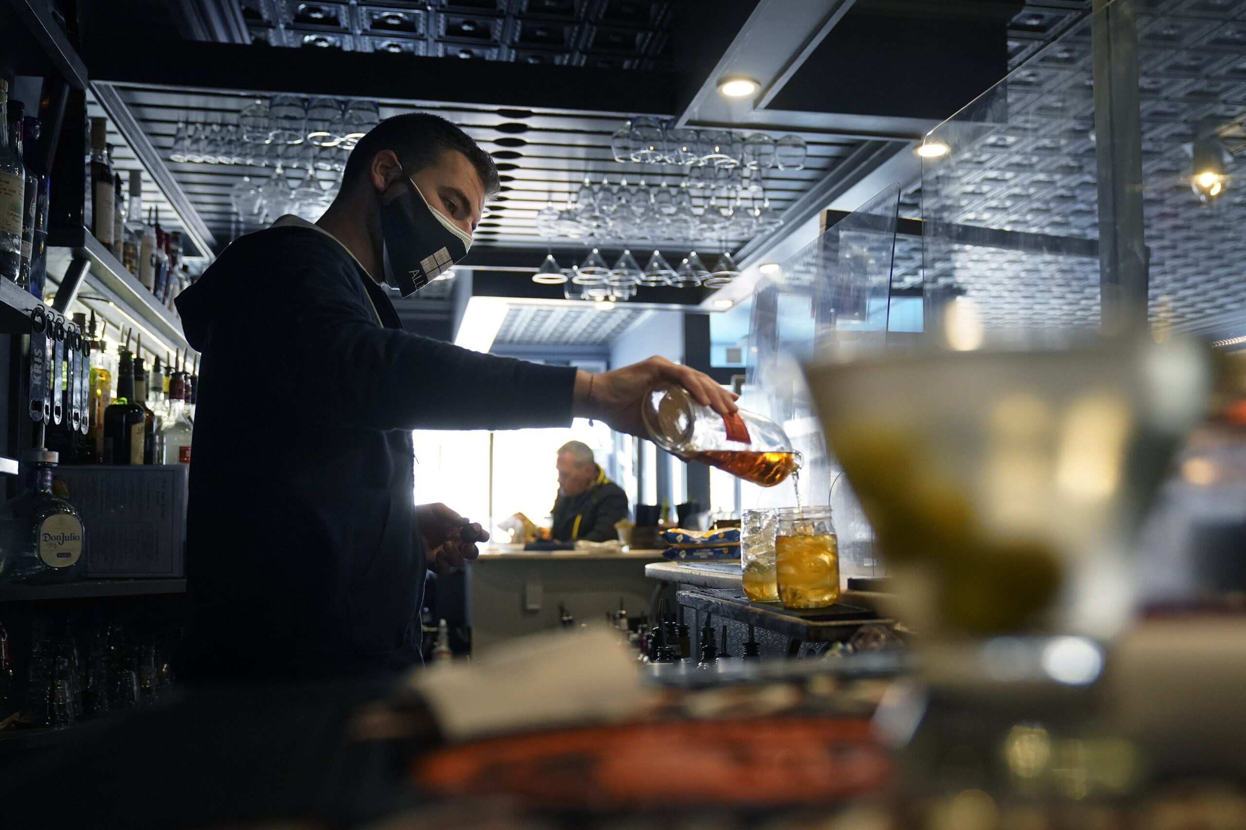 Bartender Denis Angelov pours drinks at Tin Pan Alley restaurant