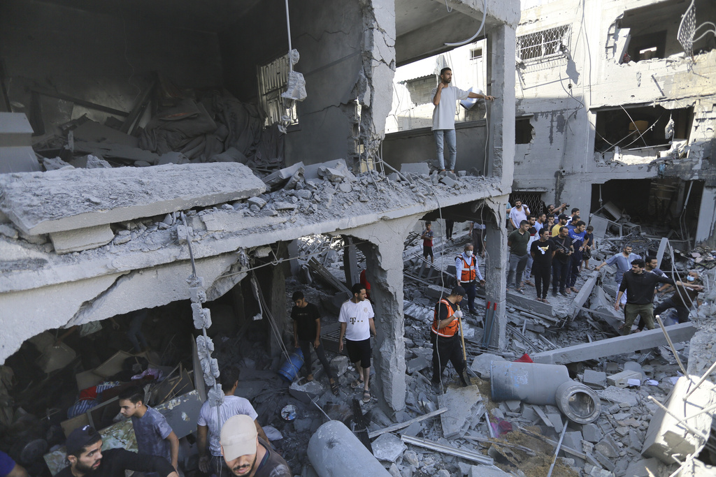 Palestinians look for survivors after Israeli airstrikes in Gaza City.