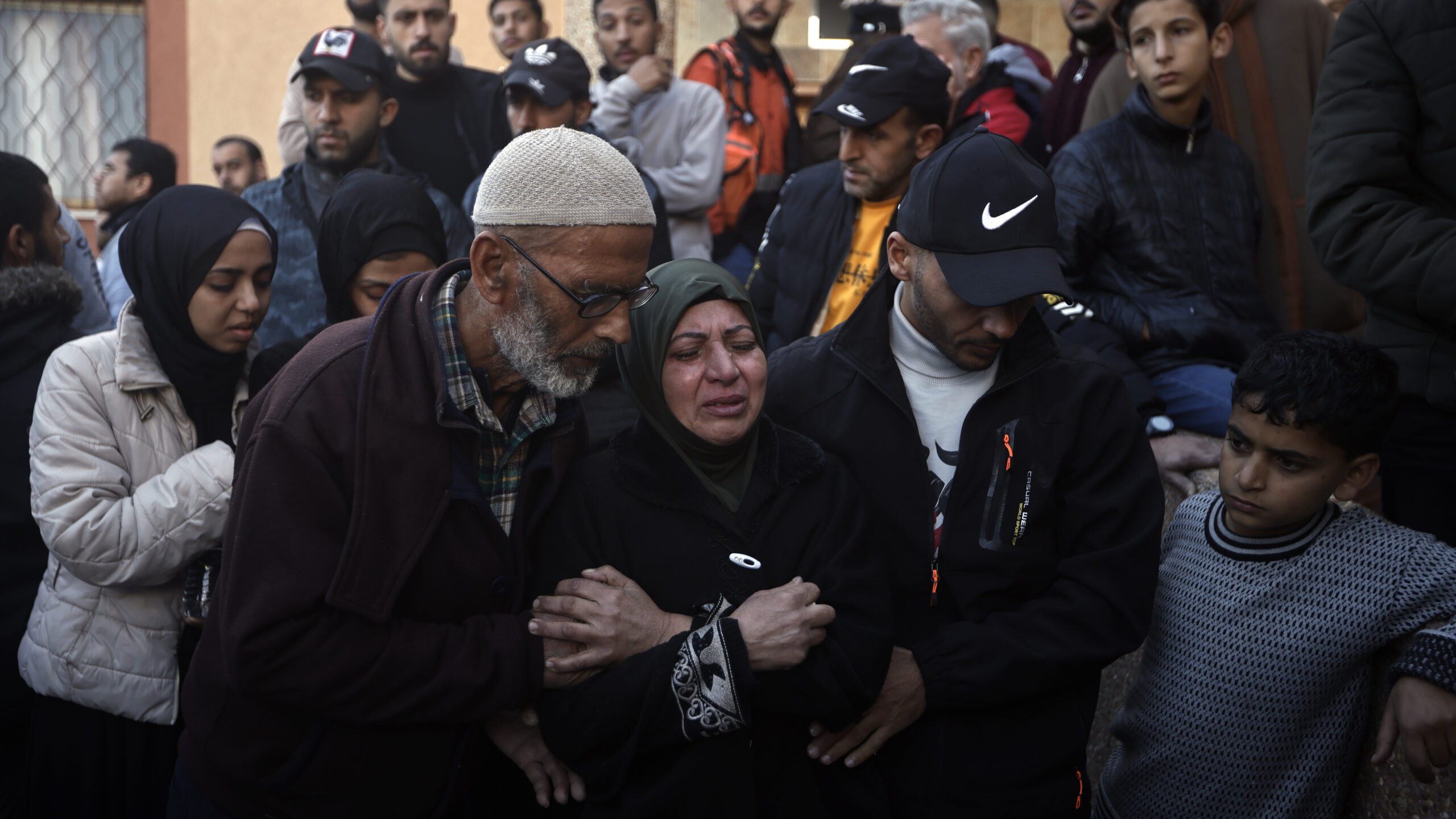 Palestinians mourn relatives killed in the Israeli bombardment of the Gaza Strip outside a morgue in Khan Younis on