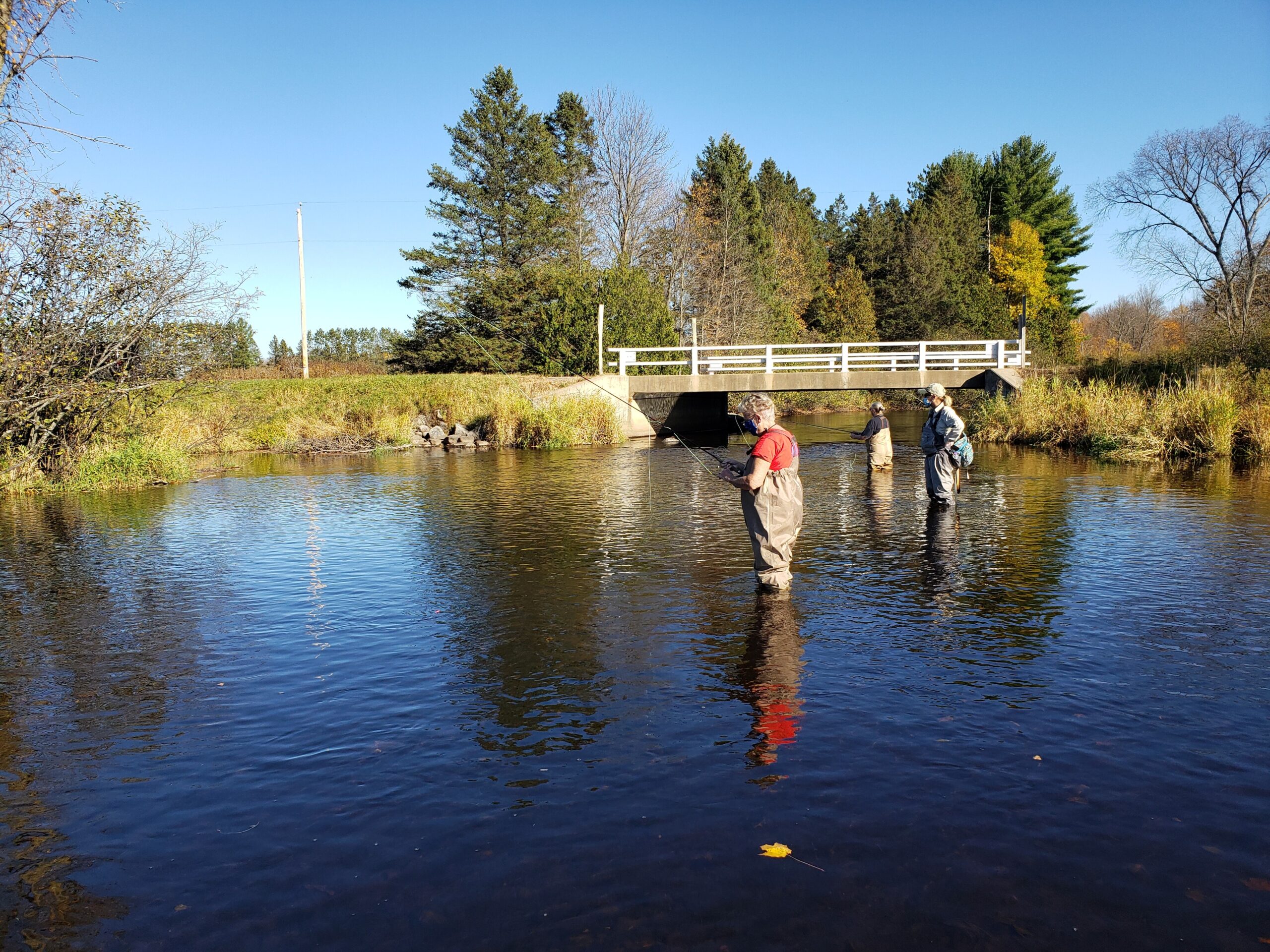 Three people go fly-fishing in a Wisconsin river