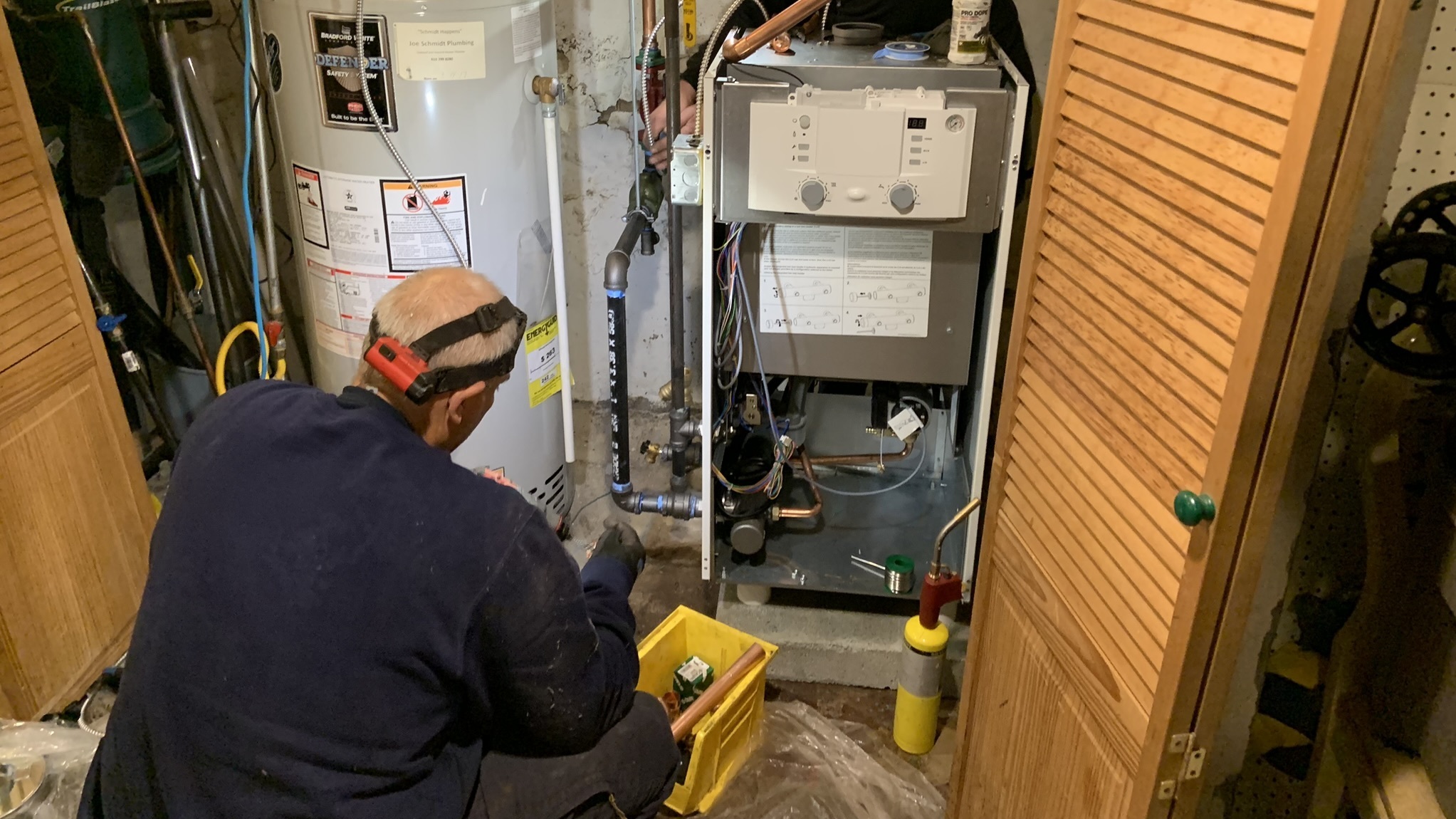 Oval Heating and A/C workers install a more efficient condensing gas boiler in a Sharon Hill, Pennsylvania home. New