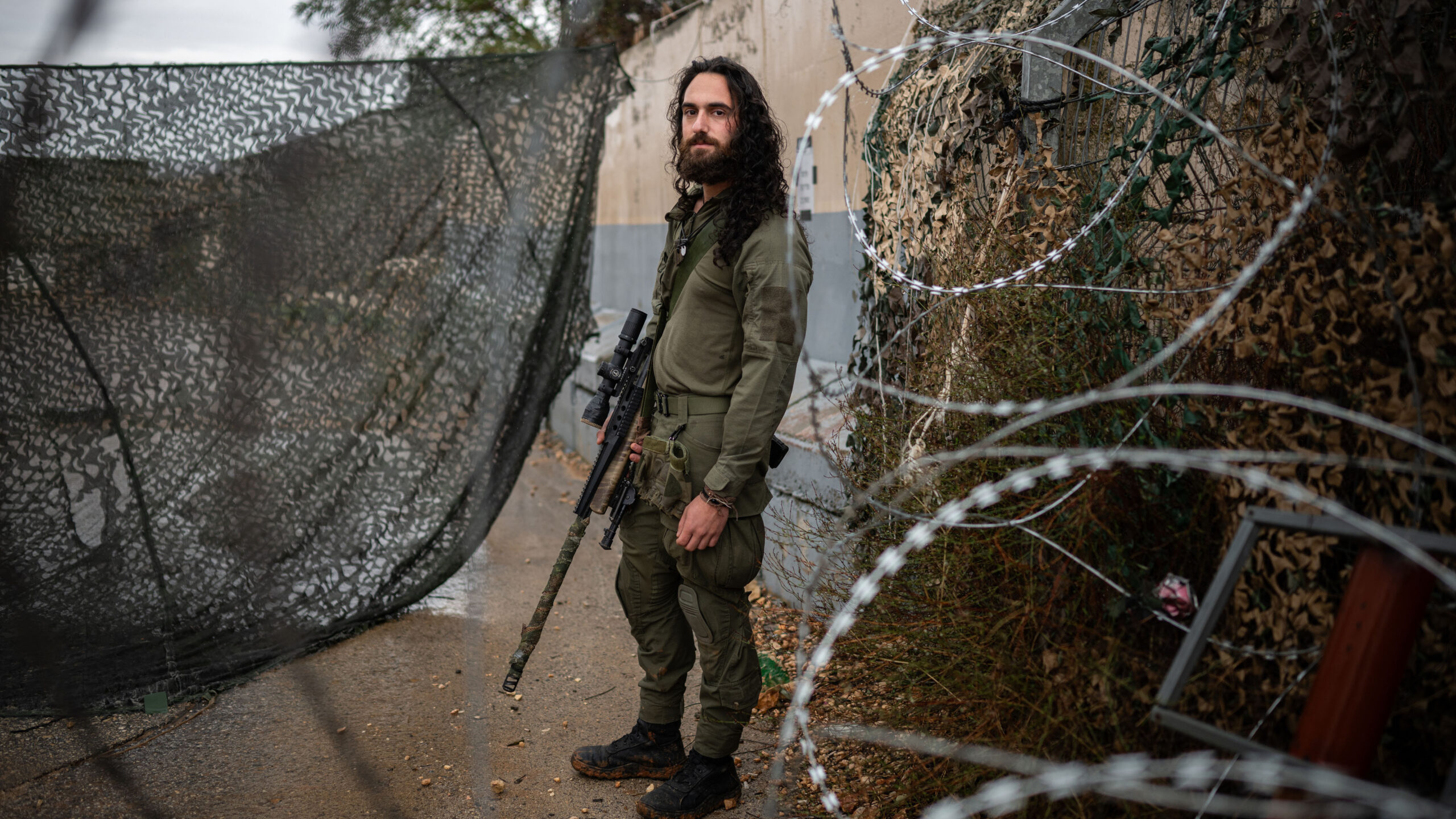 Amit Michelson, an Israeli military reservist, stands for a portrait at a military base near the border with Lebanon in