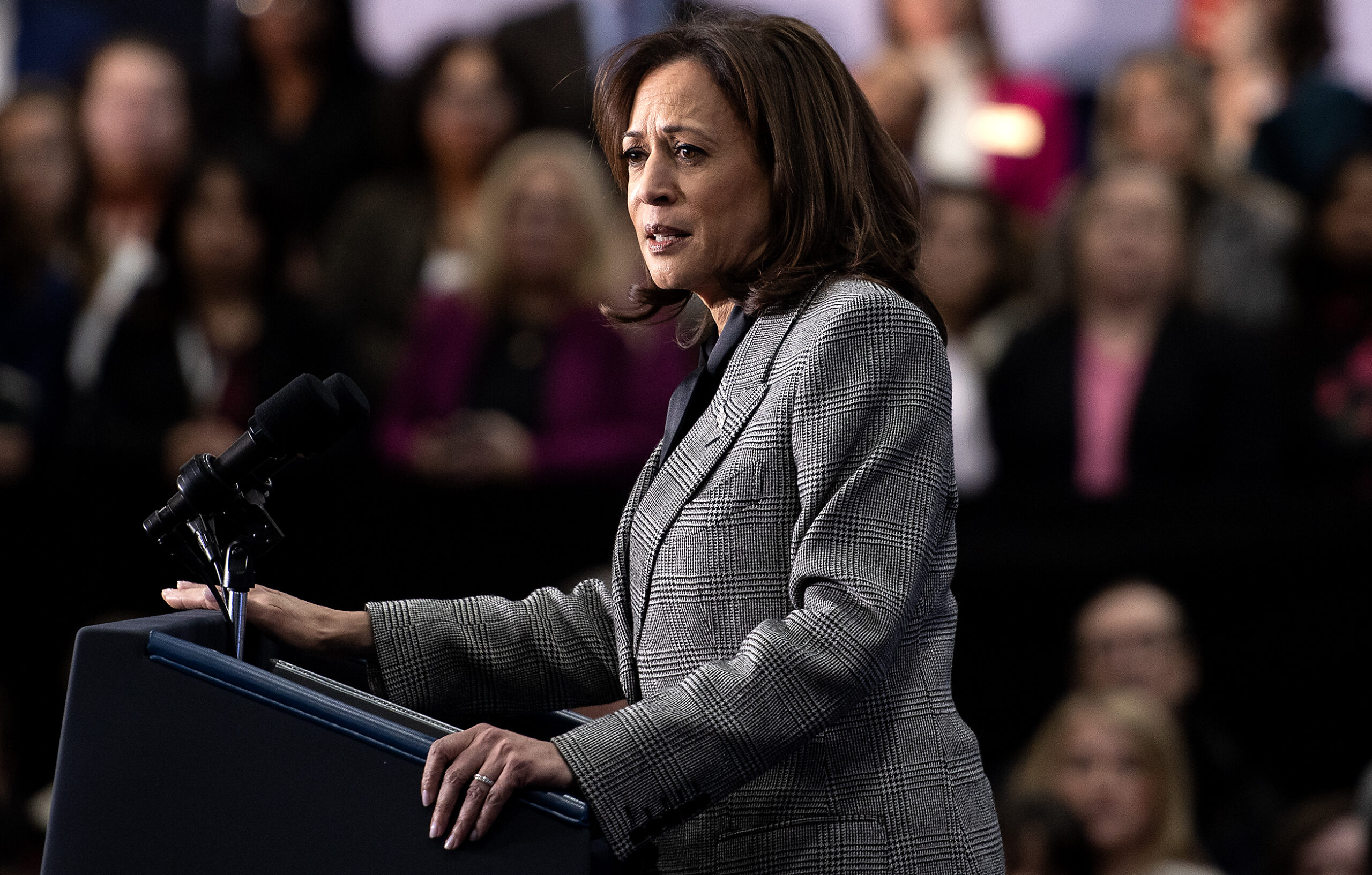 VP Harris has a concerned expression as she speaks at the podium.