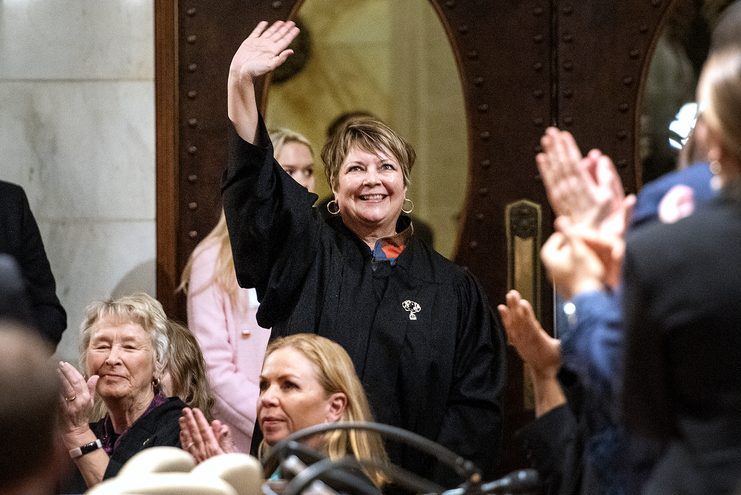 Wisconsin Supreme Court Justice Janet Protasiewicz smiles as she waves to the other attendees.