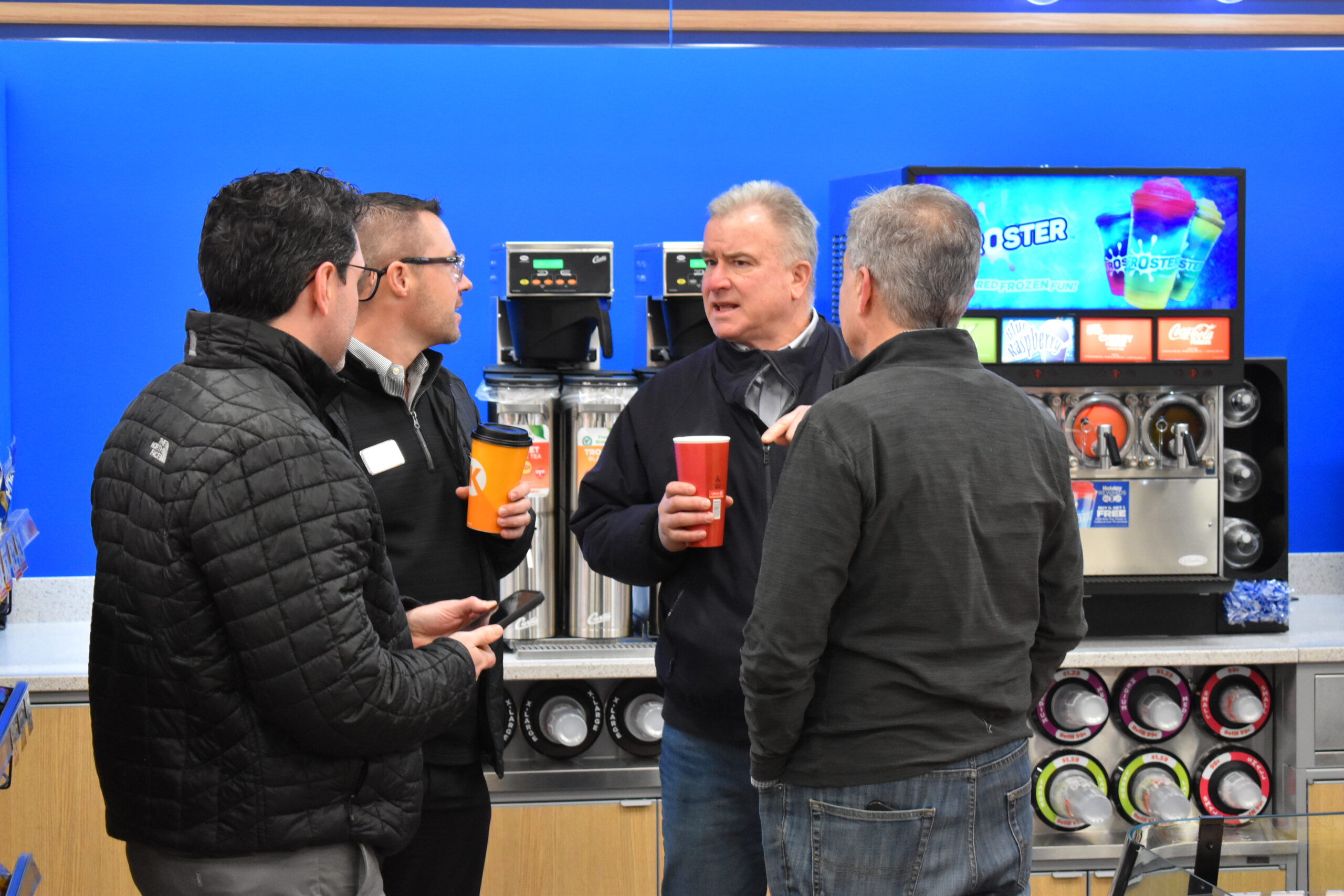 People mingle and talk during a grand opening event for a Circle K store in Green Bay