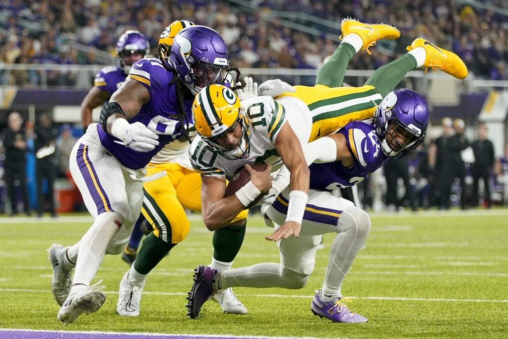 Green Bay Packers' Jordan Love dives into the end zone for a touchdown during the first half of an NFL football game against the Minnesota Vikings