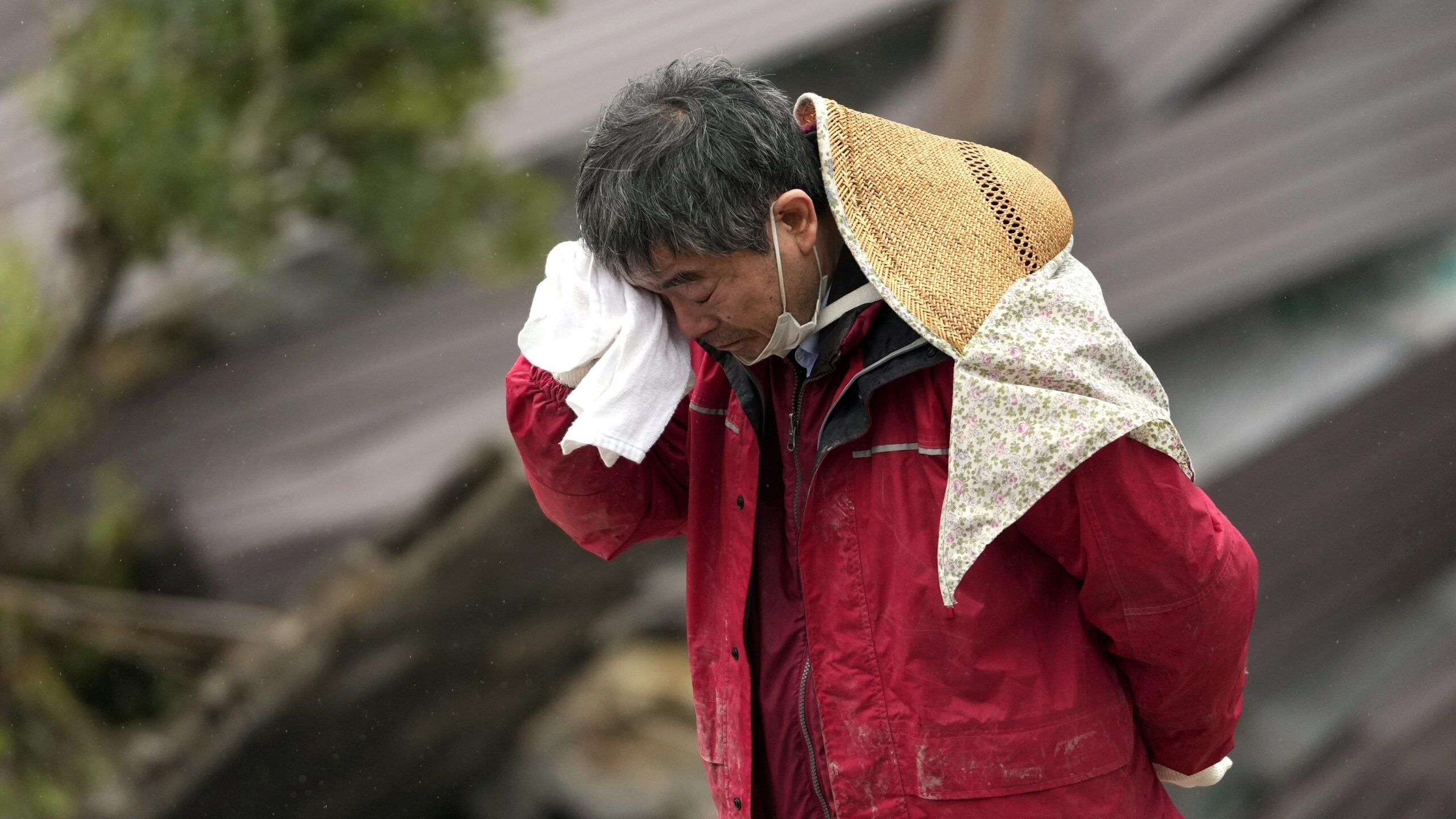 A man cries as a body of his family member was found from a collapsed house caused by powerful earthquake in Suzu,