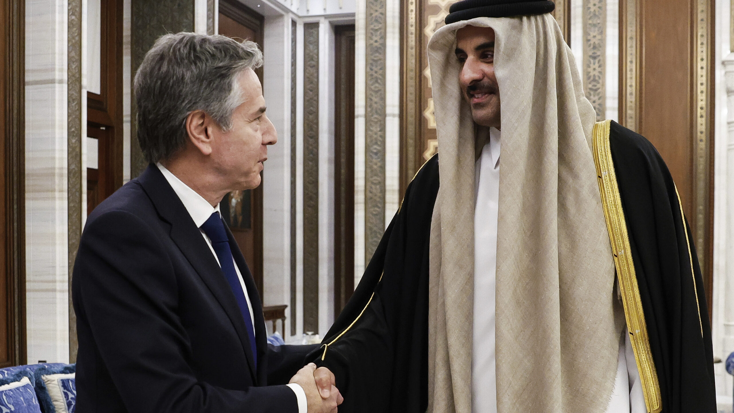 U.S. Secretary of State Antony Blinken, left, shakes hands with Qatar's Emir Sheikh Tamim Bin Hamad Al Thani, during