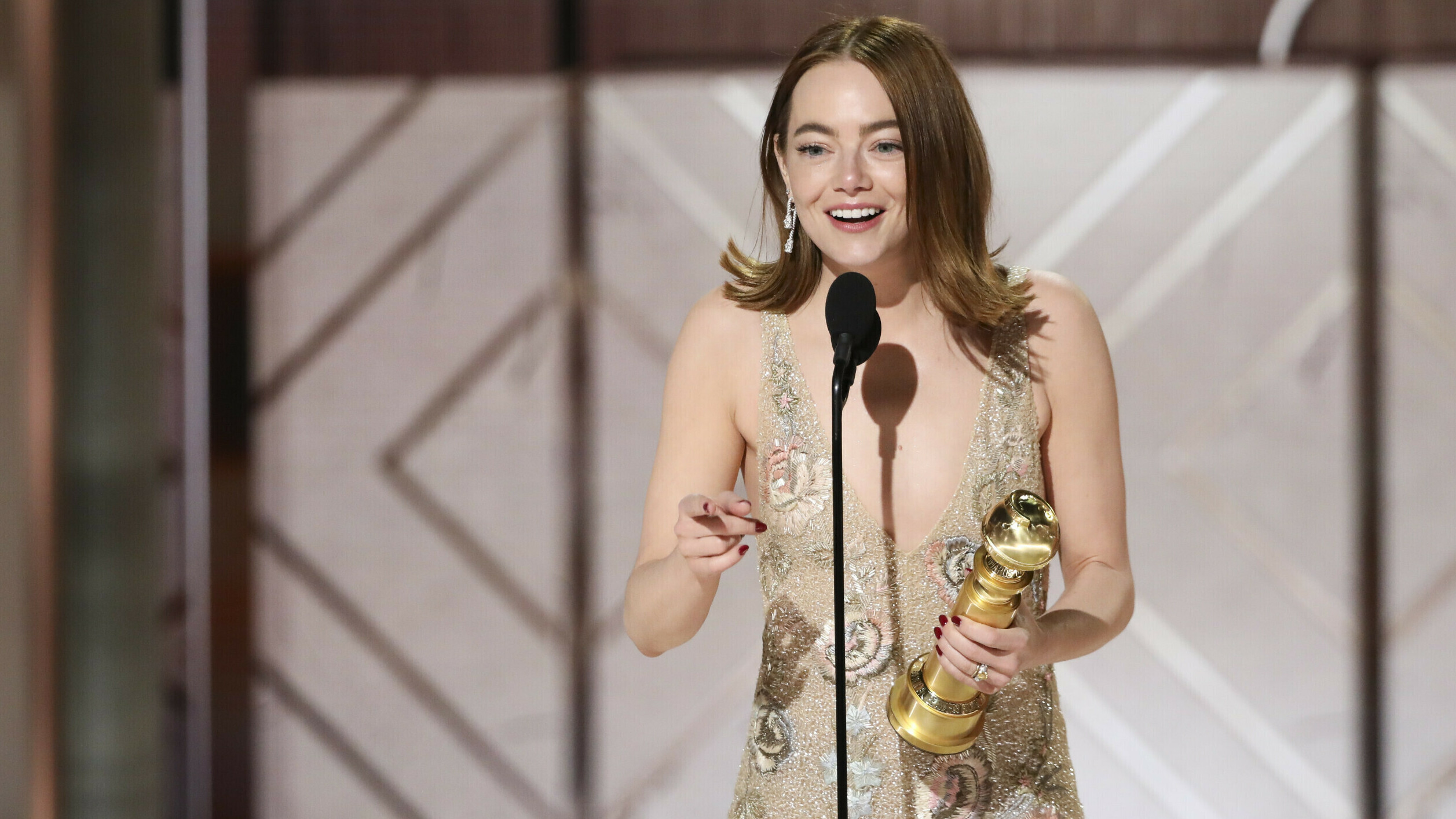 This image released by CBS shows Emma Stone accepting the award for best female actor in a motion picture for her role