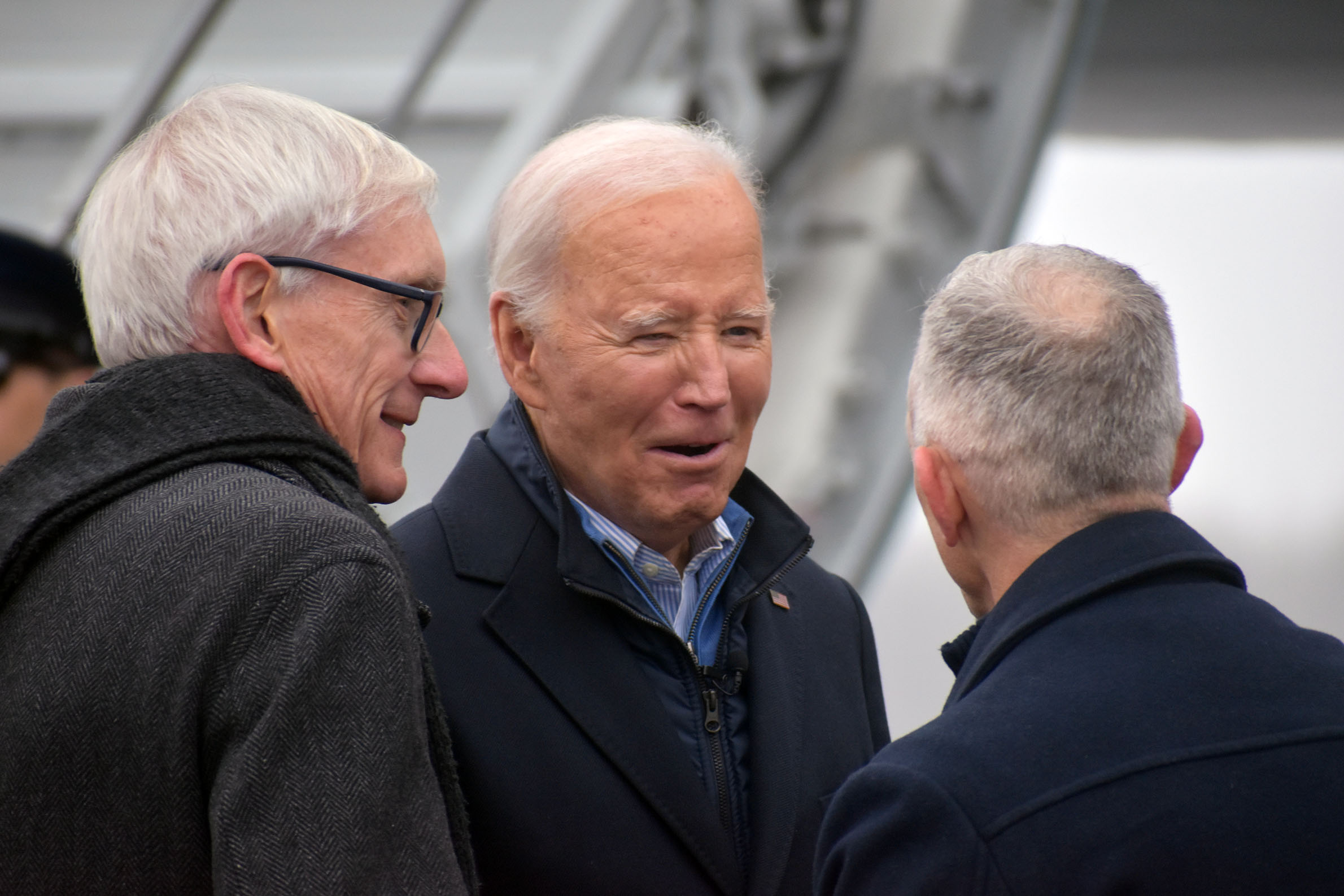 President Joe Biden greets Minnesota Gov. Tim Walz and Wisconsin Gov. Tim Evers.