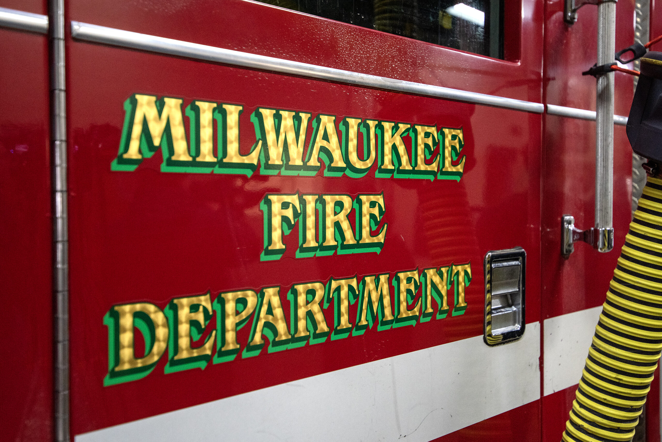 A red fire engine door with the words "Milwaukee Fire Department" on it.