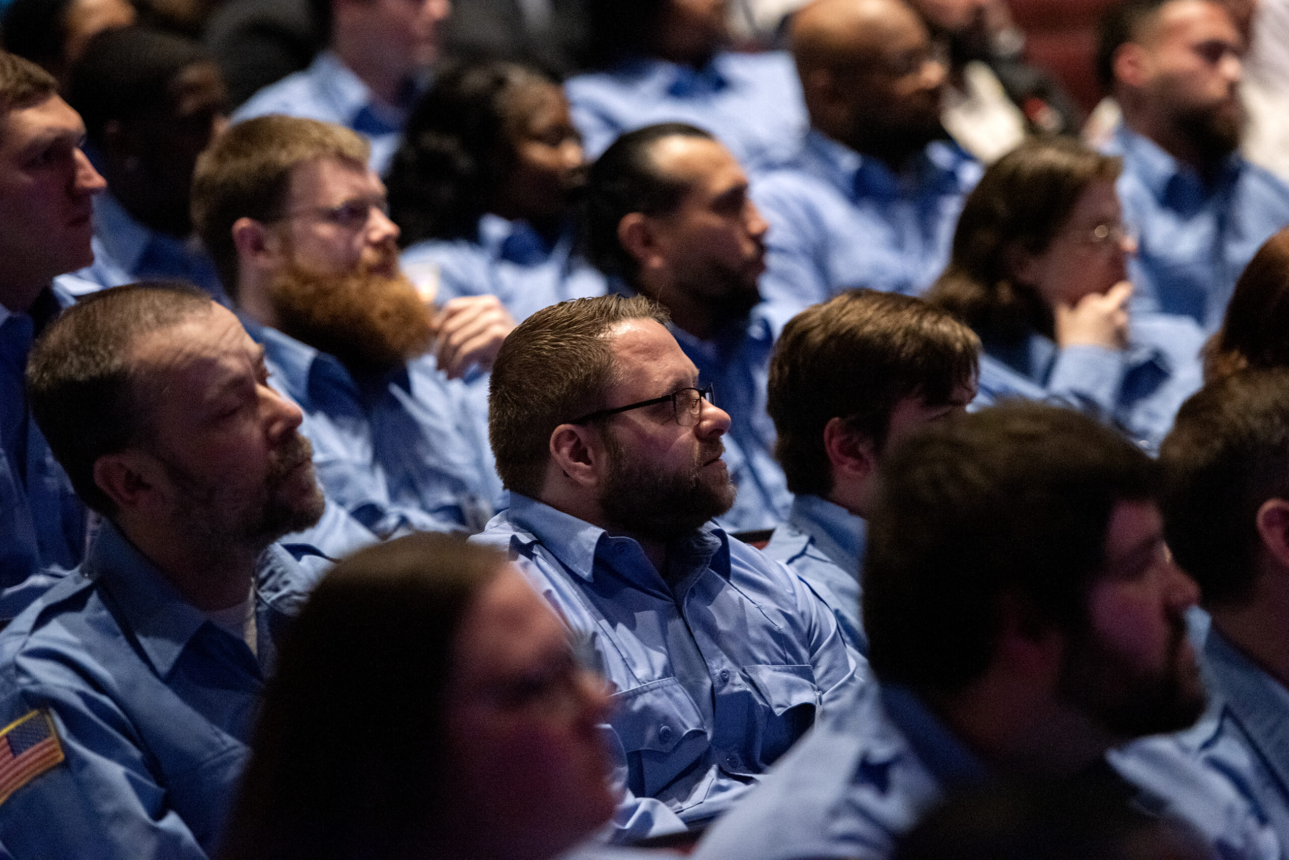 A sea of graduates sit in the crowd.