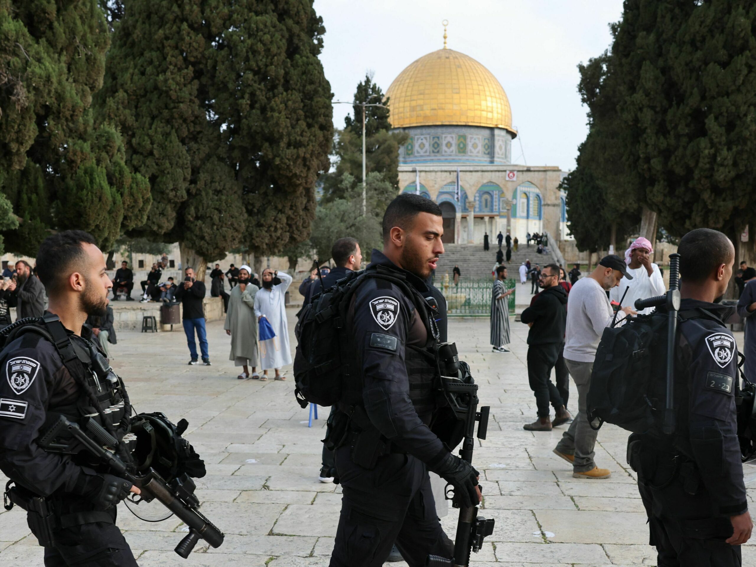 Jewish visitors walk protected by Israeli security forces at the Al-Aqsa mosque compound, also known as the Temple Mount complex to Jews, in Jerusalem on April 9, 2023, during the Muslim holy fasting month of Ramadan, also coinciding with the Jewish Passover holiday.