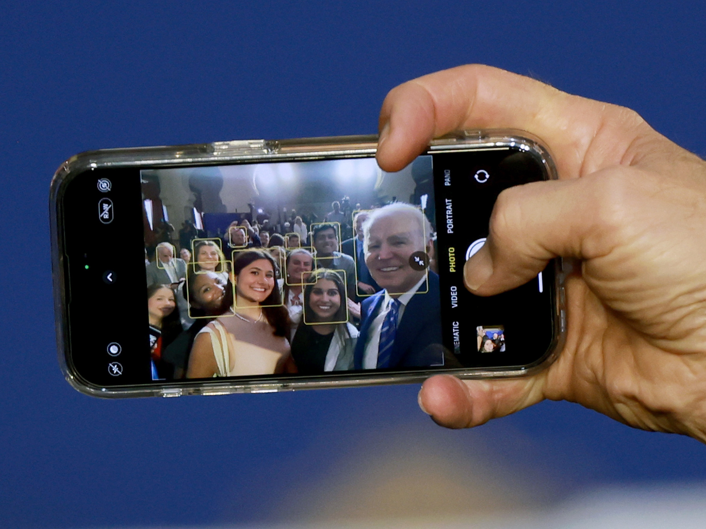 President Biden takes a selfie using a guest's phone during an event at the University of Tampa on Feb. 9, 2023.