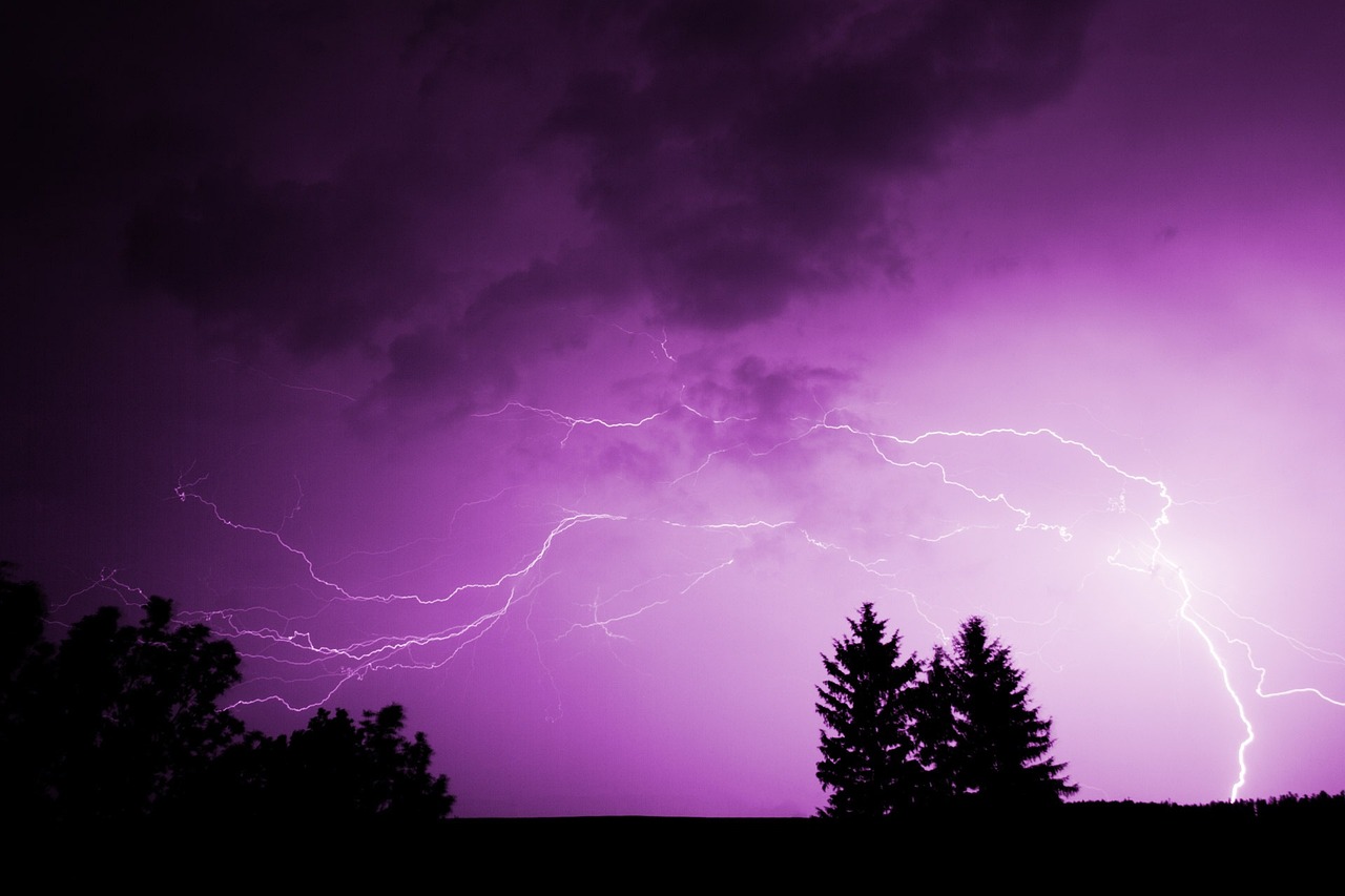 Lightening against a purple sky.
