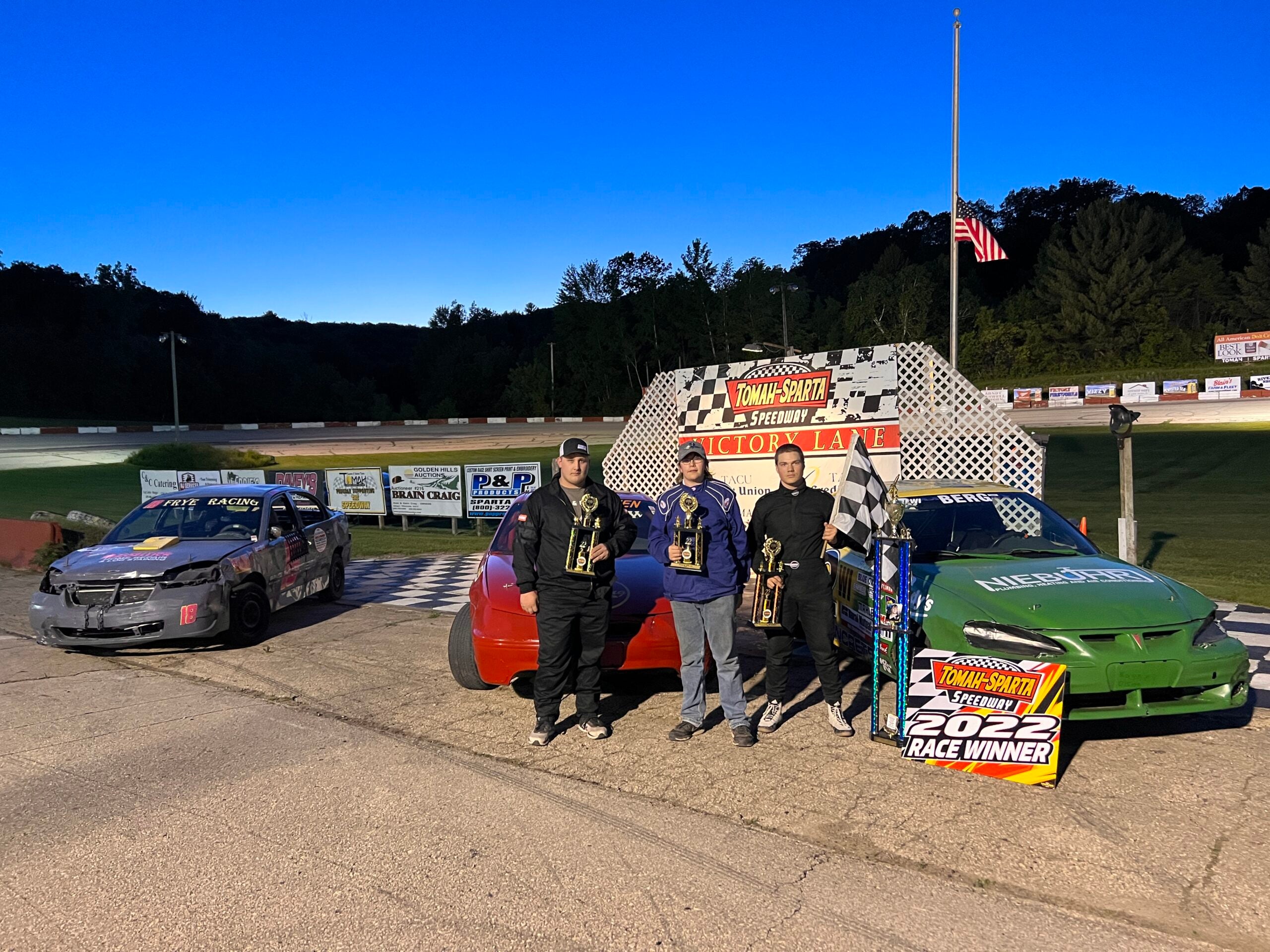 Student racers stand in victory lane at the Tomah/Sparta speedway