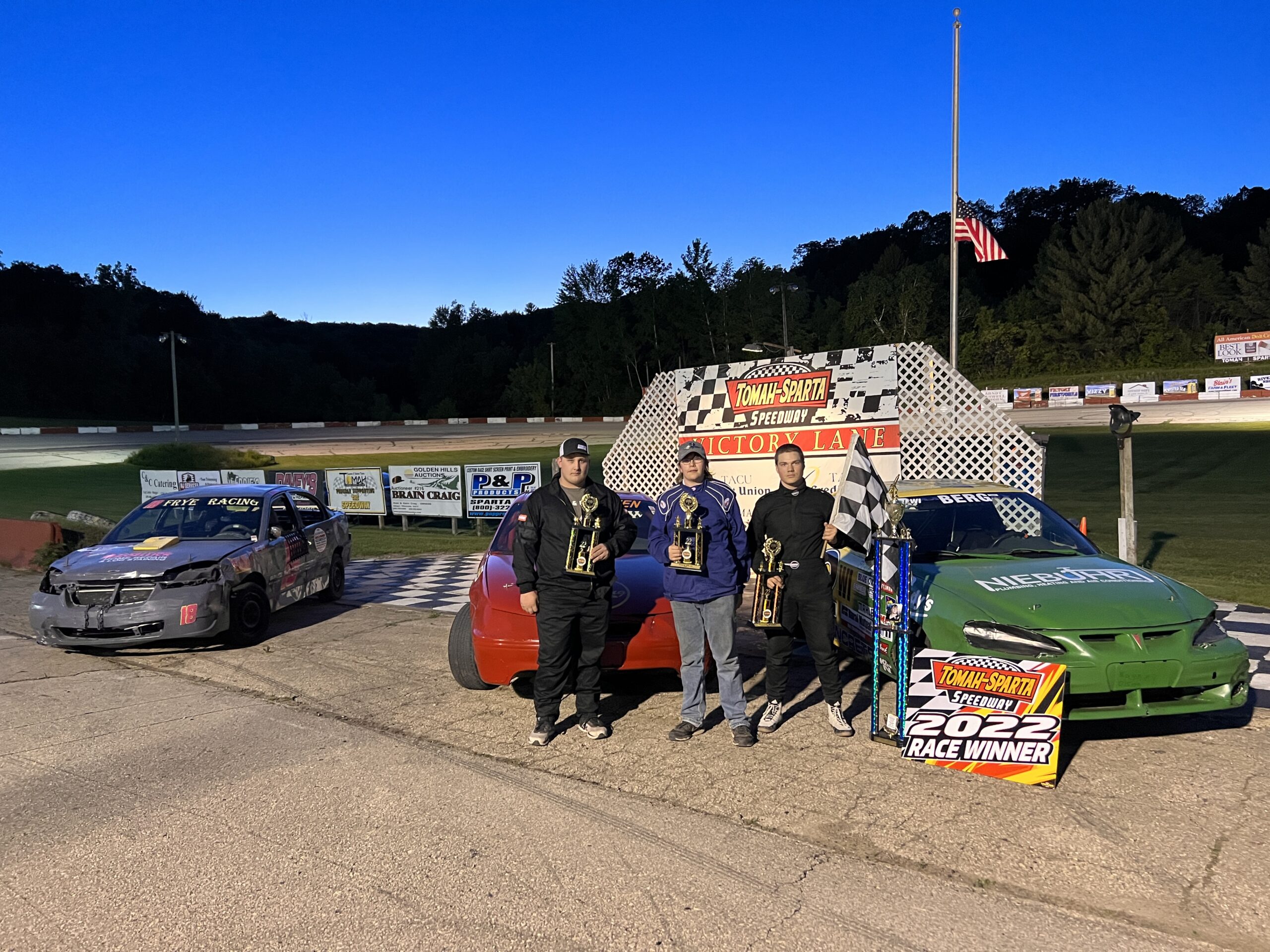 Student racers stand in victory lane at the Tomah/Sparta speedway