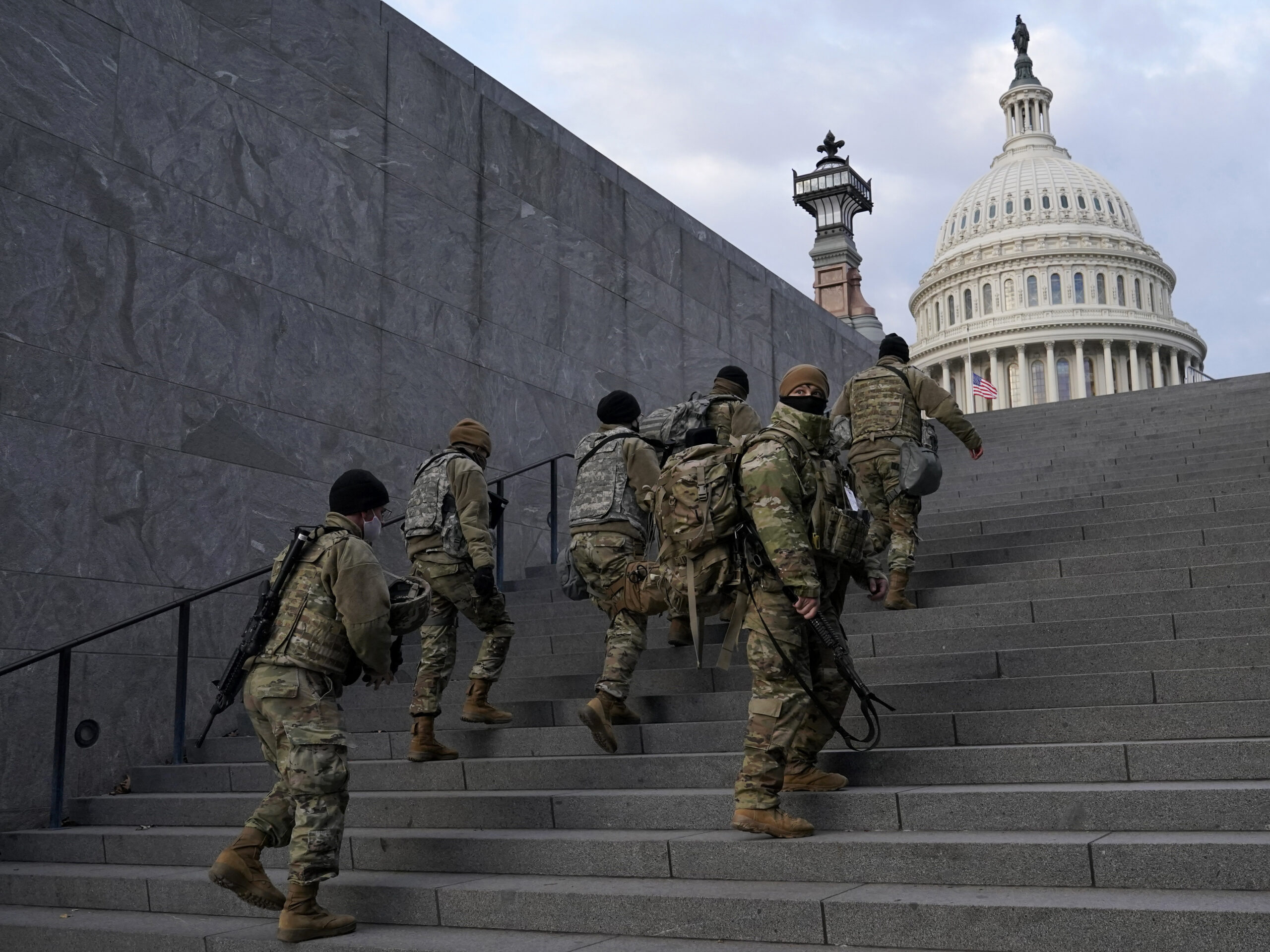 National Guard members take a staircase toward the U.S. Capitol building before a rehearsal for President-elect Joe Biden's Inauguration in Washington on Jan. 18, 2021. Experts in constitutional law and the military say the Insurrection Act gives presidents tremendous power with few restraints.