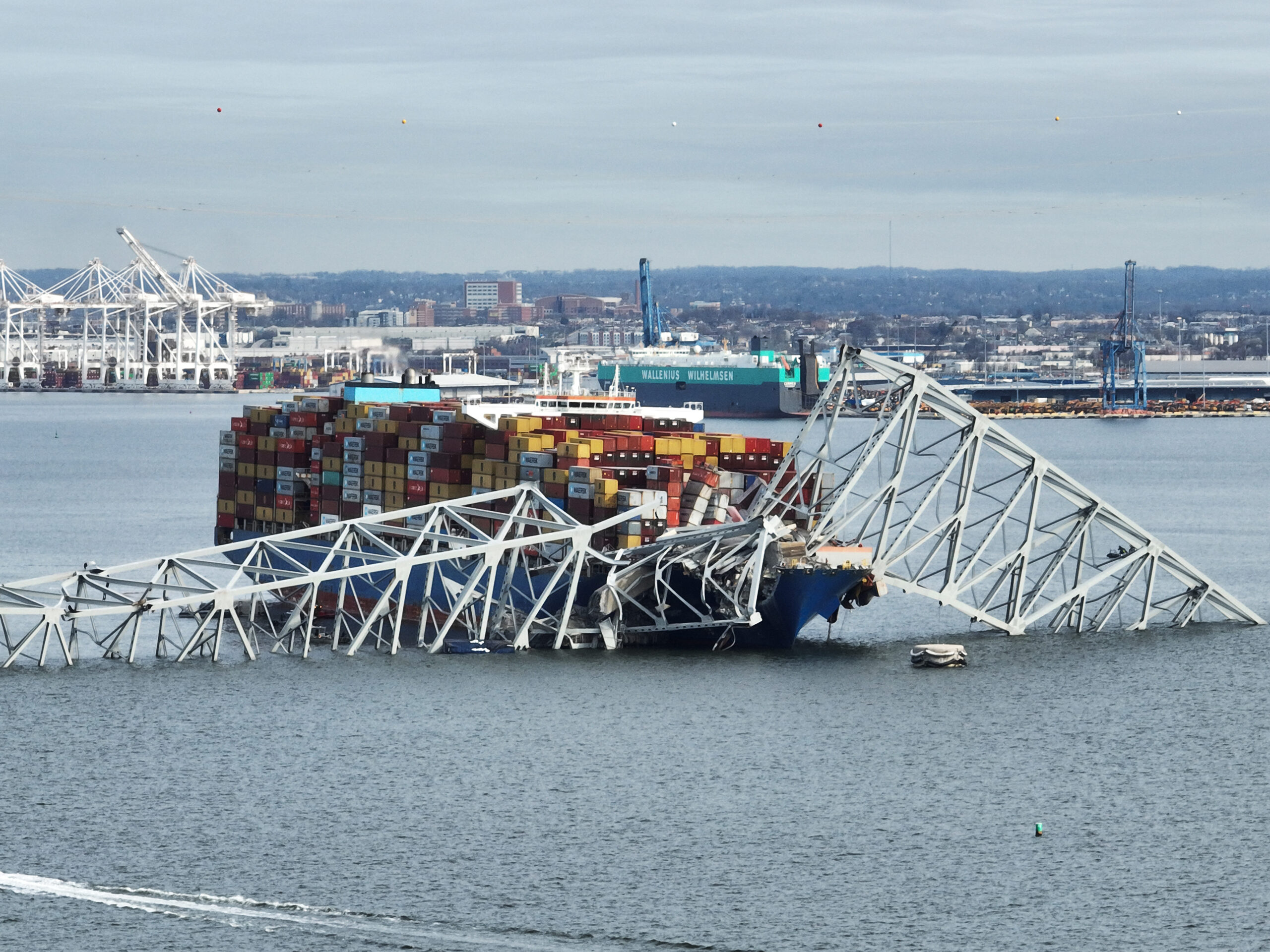A steel frame from the collapsed Francis Scott Key bridge in Baltimore covers the top of the Dali ship. The container ship crashed into the bridge on Tuesday.