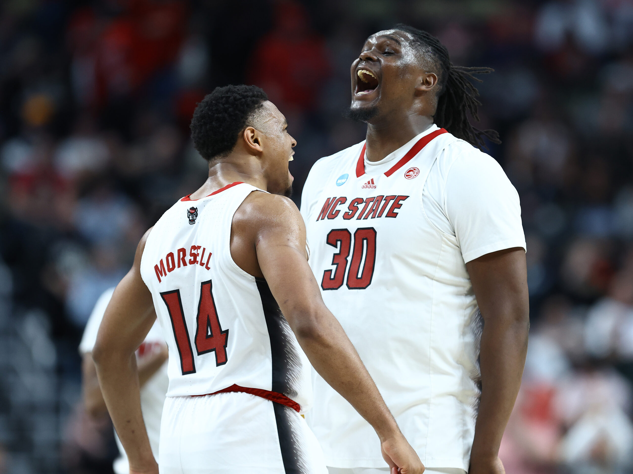 Casey Morsell and DJ Burns Jr. of the North Carolina State Wolfpack celebrate during their win over 14-seed Oakland in the first weekend of the NCAA Tournament.