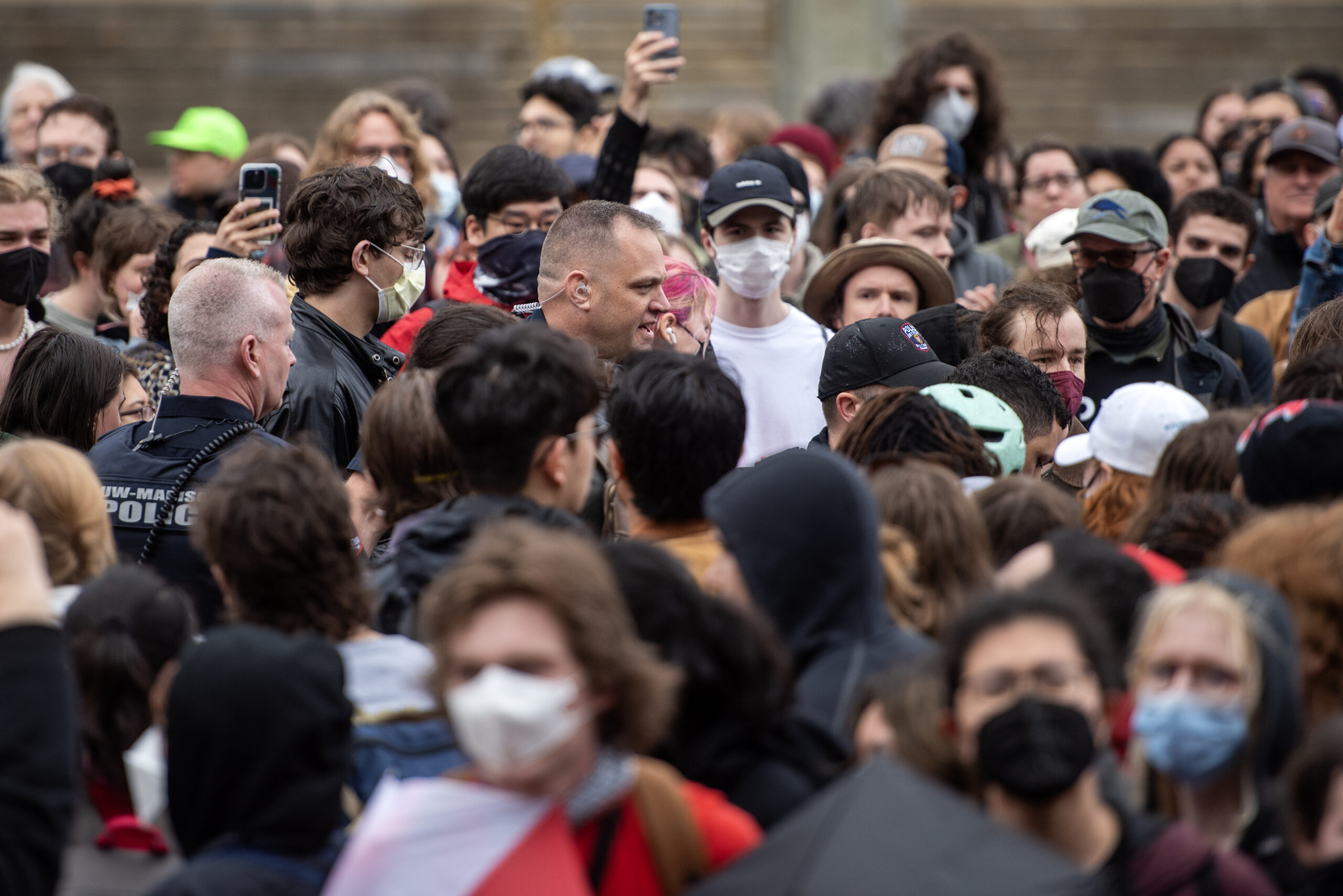 Police can be seen in a crowd of people.