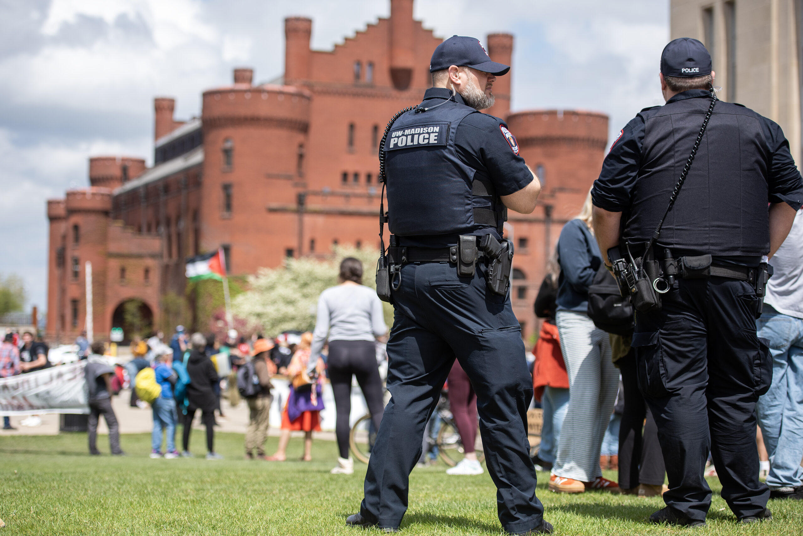 Two UW-Madison police officers stand near the outdoor protest demonstration.